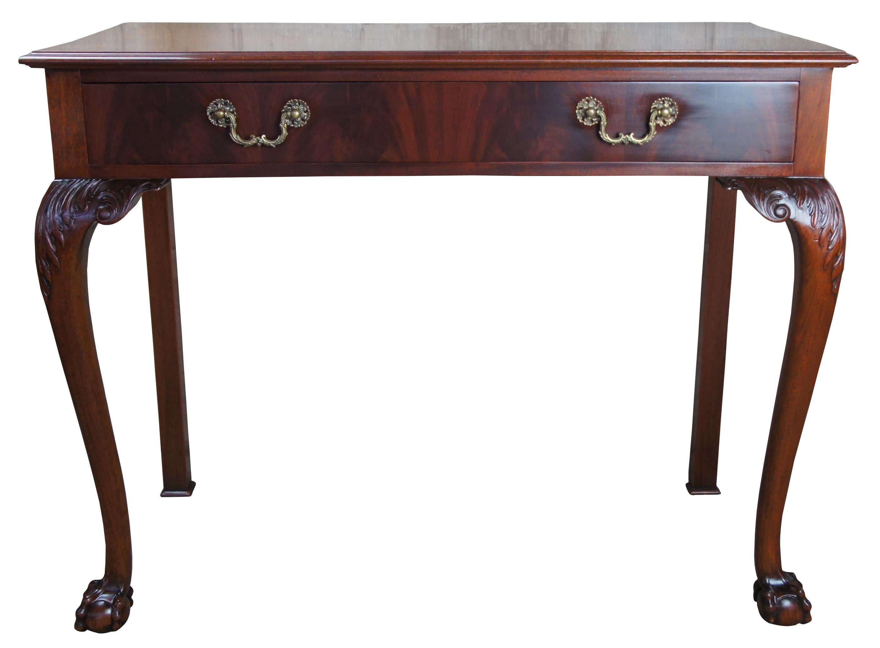 Antique Chippendale style flame mahogany carved buffet server ball claw feet

Quaint Chippendale style buffet. Features a flame mahogany central drawer with compartments for silverware, resting upon cabriole legs with intricate acanthus carvings