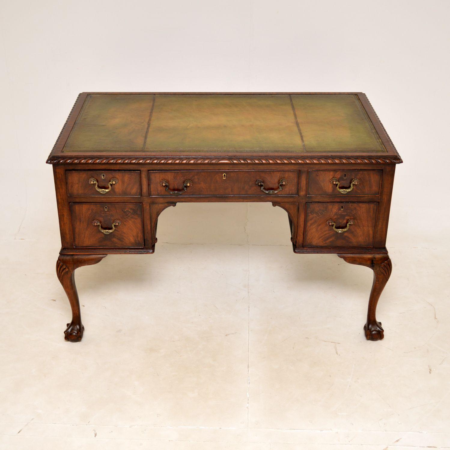 A fantastic antique desk in the Chippendale style. This was made in England, it dates from around the 1890-1910 period.

It is very well made, sitting on beautiful cabriole legs with shell carving at the knees, terminating in claw and ball feet. The