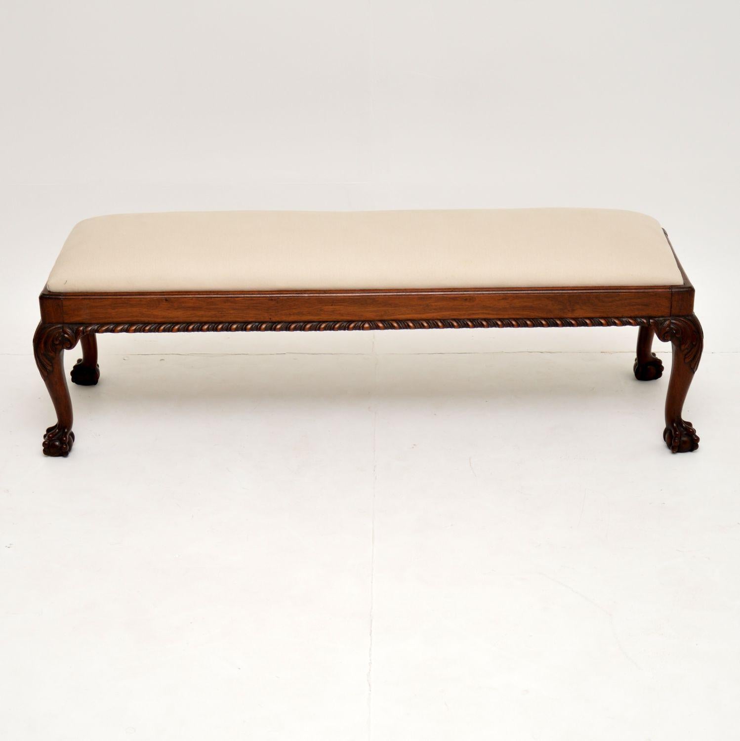 Antique mahogany Chippendale style long footstool with a drop in panel that’s just been upholstered in our regular cream natural cotton fabric. The frame is in excellent original condition. It has a gadrooned bottom edge, with crisply carved legs