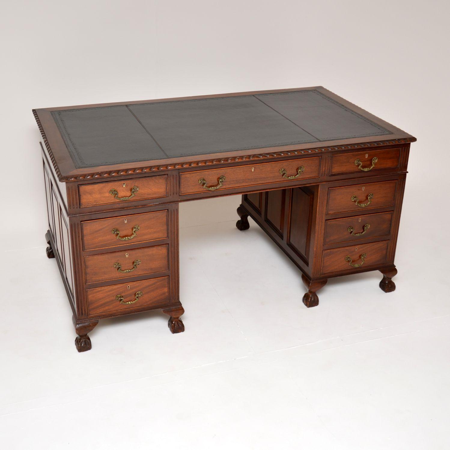 An excellent antique desk in the classic Chippendale style. This was made in England, it dates from around the 1900-1920 period.

It has a fantastic design and is of amazing quality. The top has gadrooned edges, there are panelled sides and