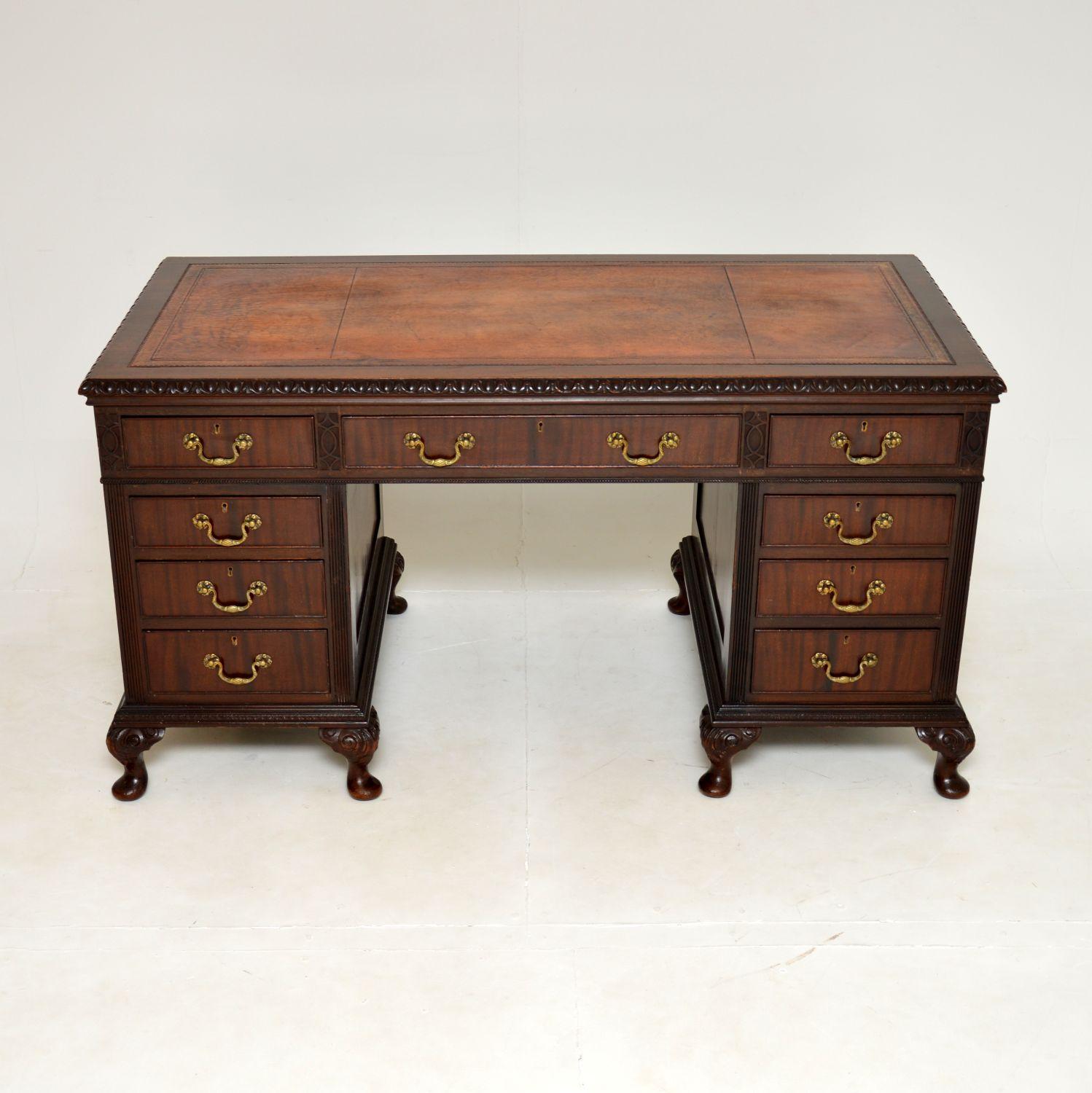An impressive and very well made antique pedestal desk. This is in the Chippendale style, it was made in England and dates from the 1920’s.

It is of superb quality and is a great size, with a wide knee hole. The inset leather top is gold tooled and