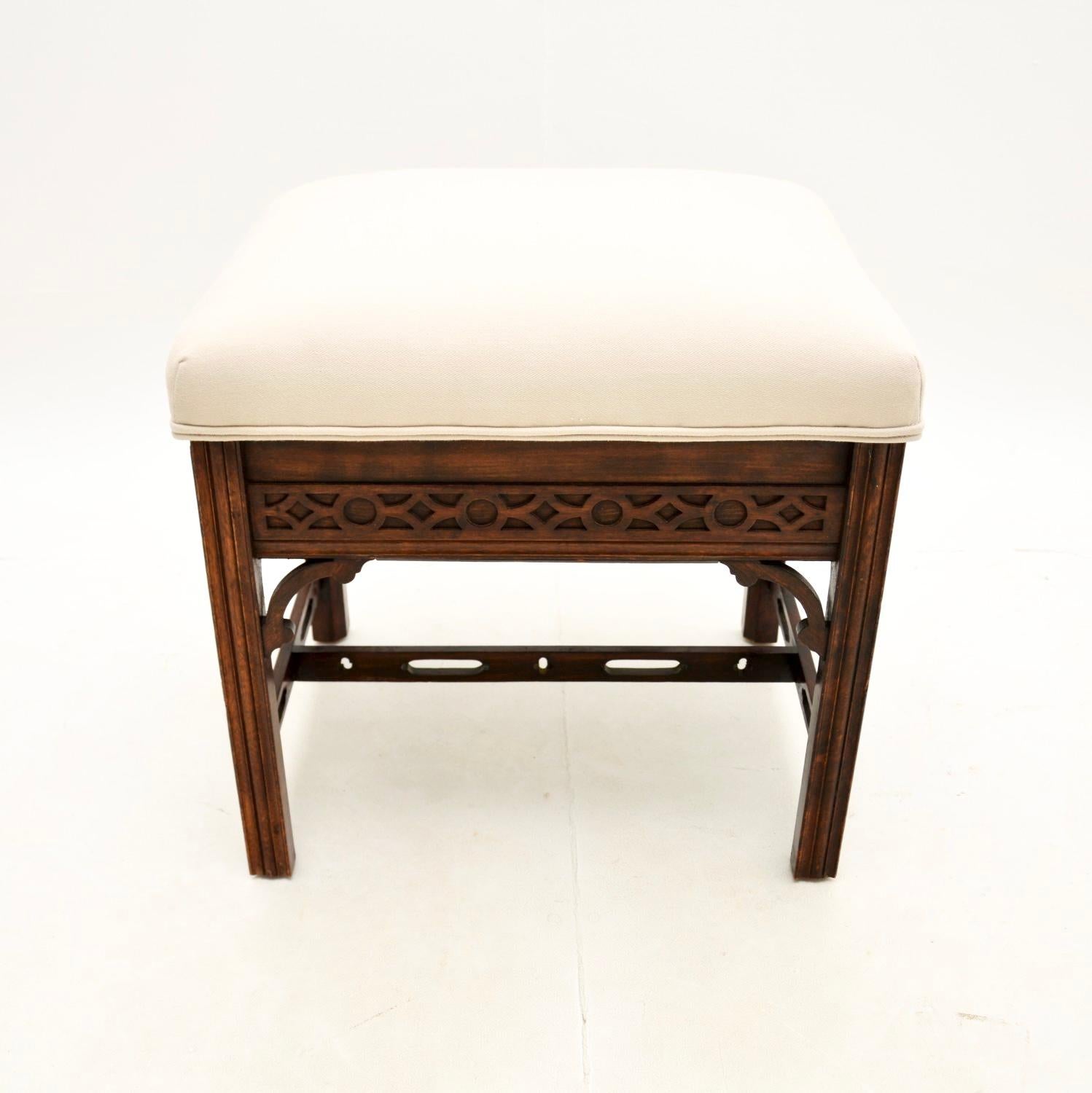 A smart and extremely well made antique Chippendale Style piano stool. This was made in England, it dates from around the 1890-1900 period.

It is of fine quality, the frame has beautiful carving, pierced fretwork under the corners and a pierced