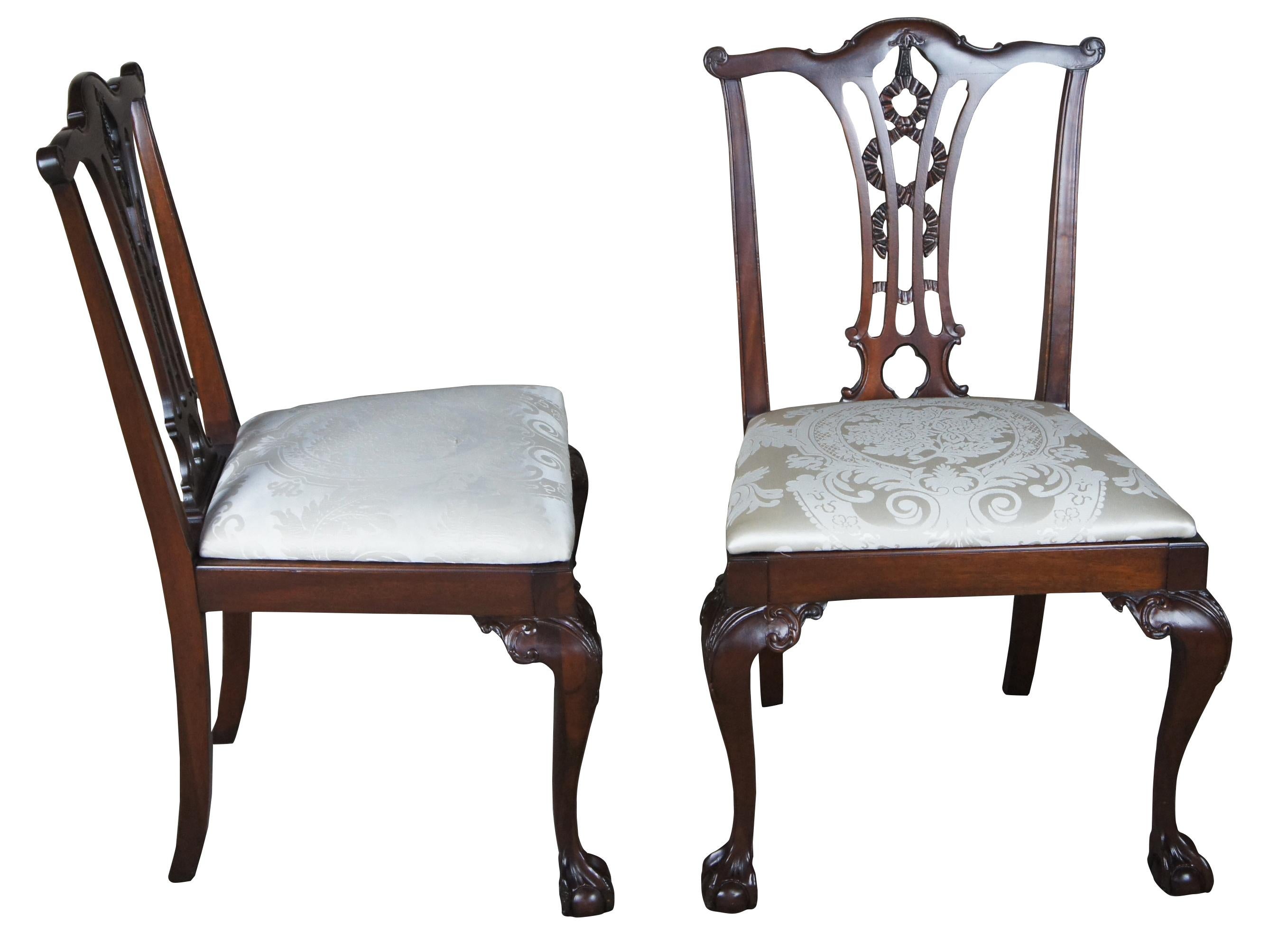 Antique Chippendale style ribbon back dining chairs ball and claw side accent

Two antique Chippendale style side chairs. Made from mahogany with vertical slat back and ribbon design. Features cabriole legs leading to ball and claw foot.
