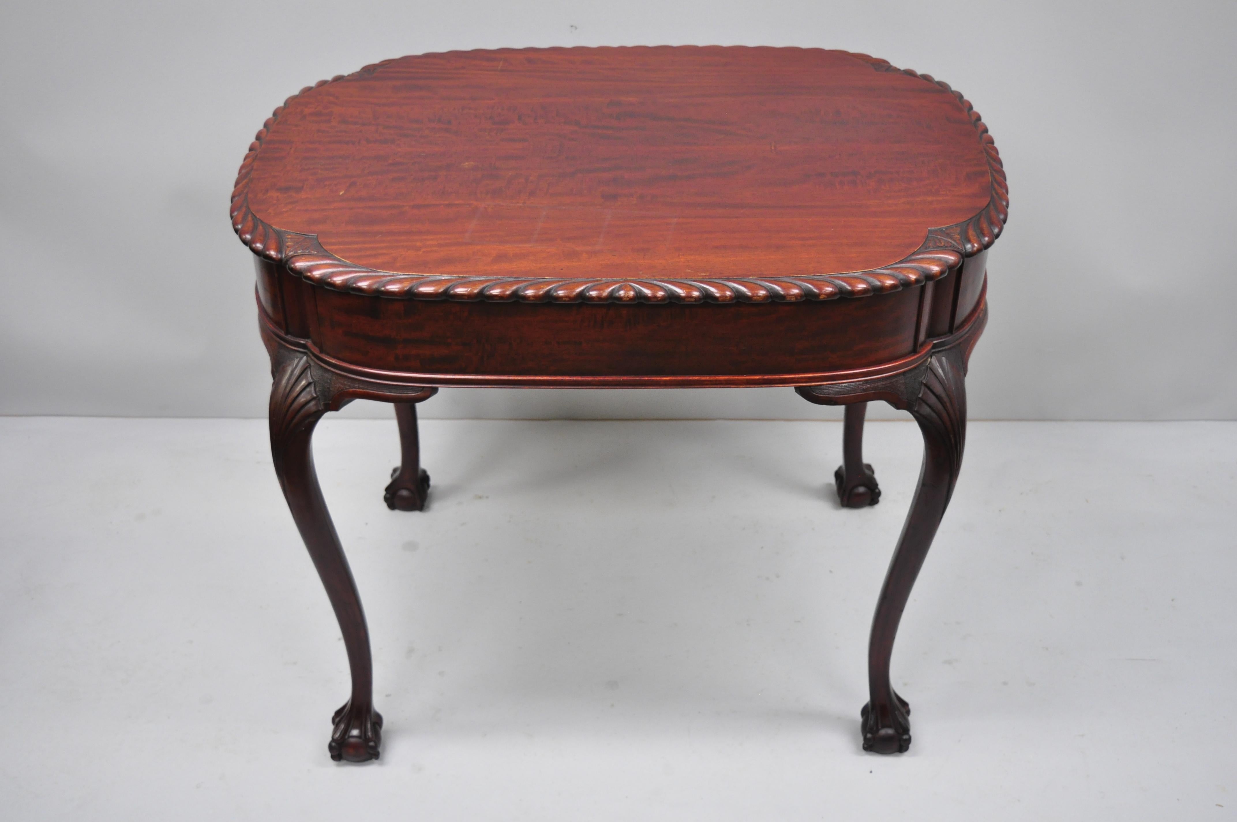 Antique Chippendale style rope carved mahogany ball and claw parlor side table. Item features shell carved knees, rope carved border, cabriole legs, shaped turtle top, solid wood construction, beautiful wood grain, and finely carved details; Very