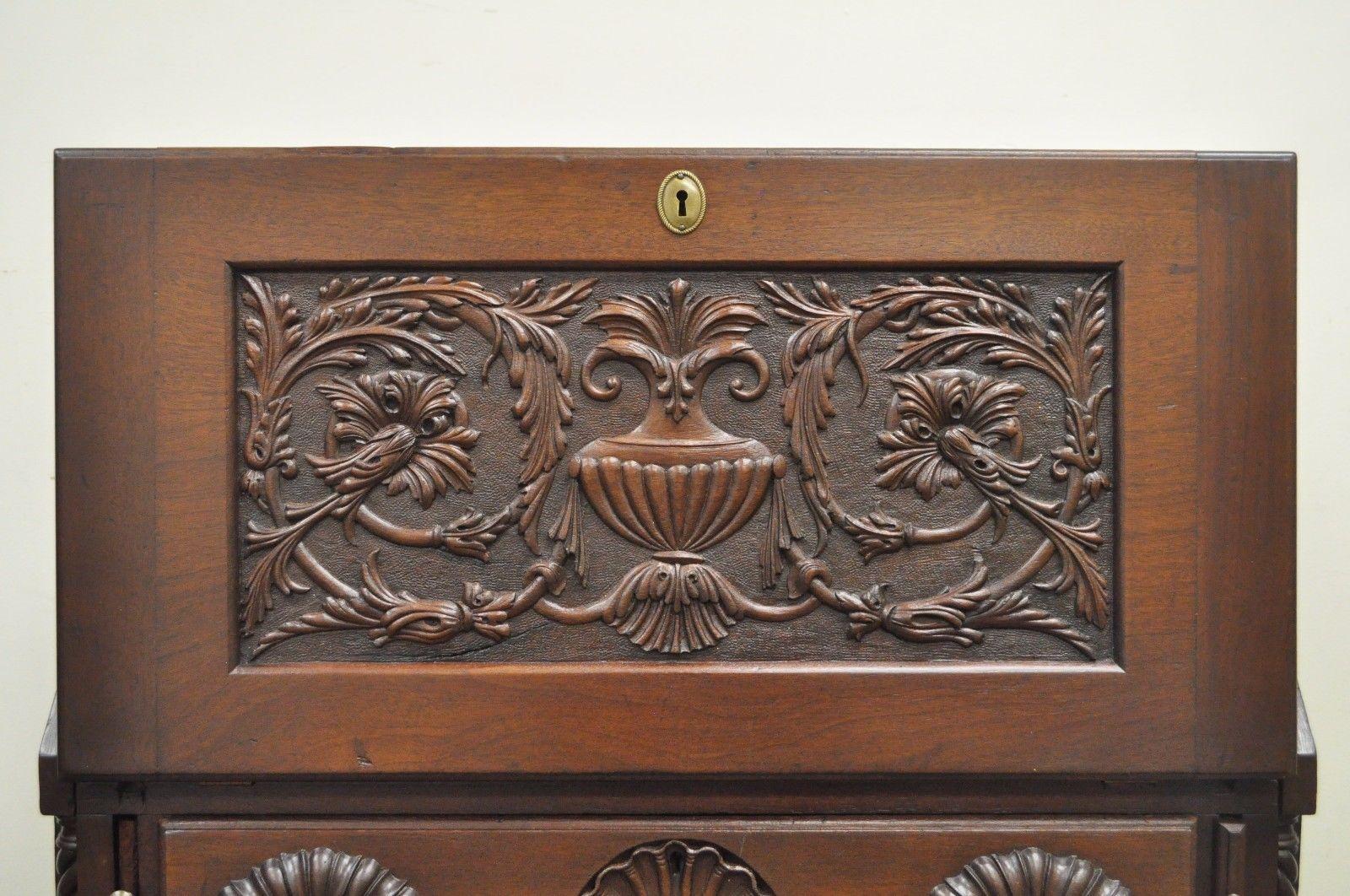 Antique Chippendale style smaller sized blockfront carved mahogany secretary desk. Item features beautiful antique blockfront desk, bell flower, acanthus, and urn carved drop front panel, shell carved top drawer, ball in claw feet, rope carved