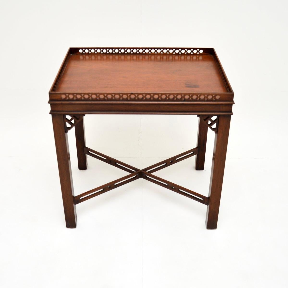 A wonderful antique Chippendale style side table. This was made in England, it dates from around the 1930’s.

This has a gorgeous design, with pierced fretwork around the top edge gallery, beneath the corners and on the stretchered base. It is a