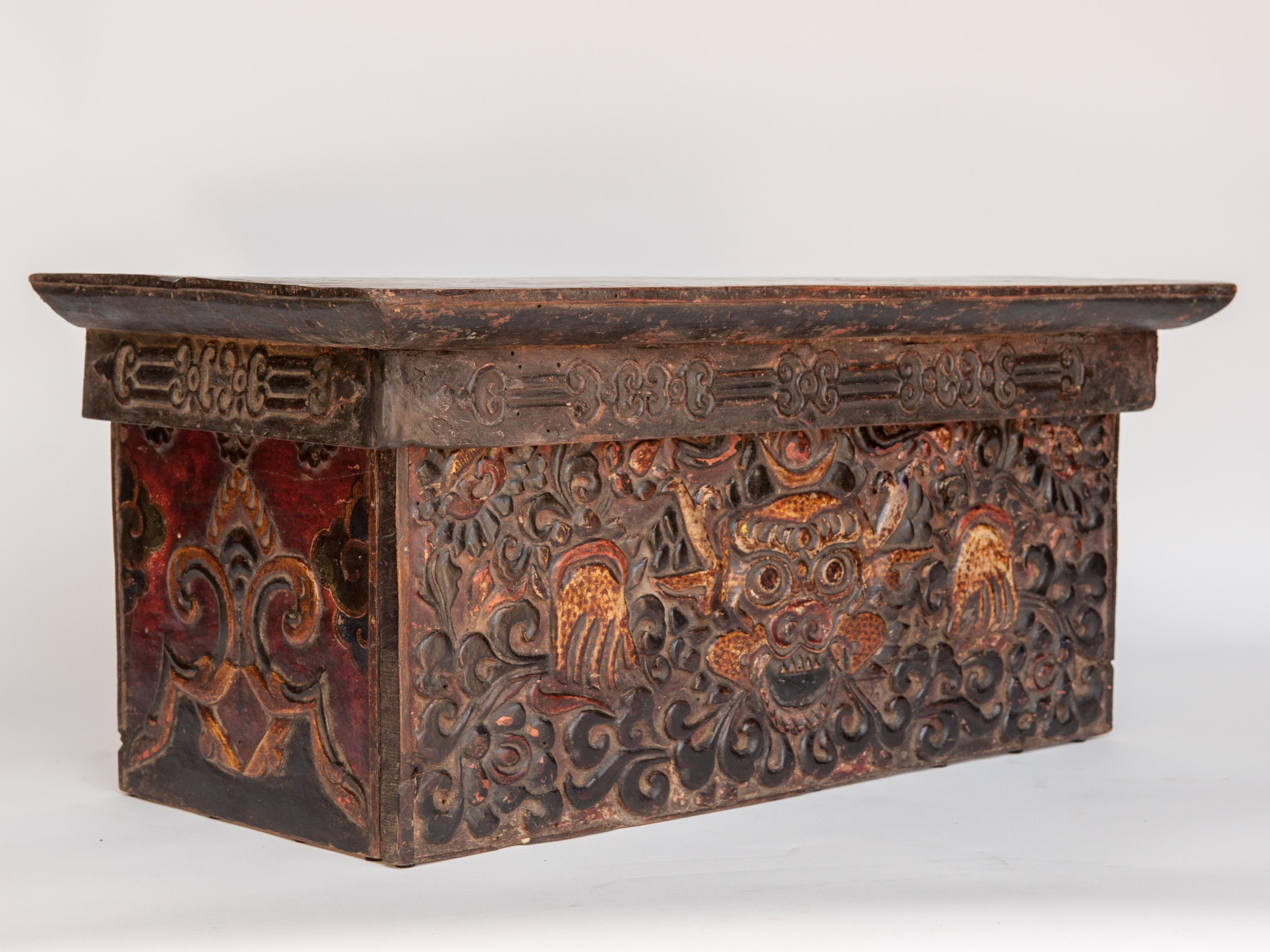 Antique Choktse - a multipurpose tea and writing table from Tibet. Hand painted. Dating to the 19th century or earlier.
This table is of light wood, probably fir, the design worked in a raised gesso technique called kyungbur, and then hand painted.