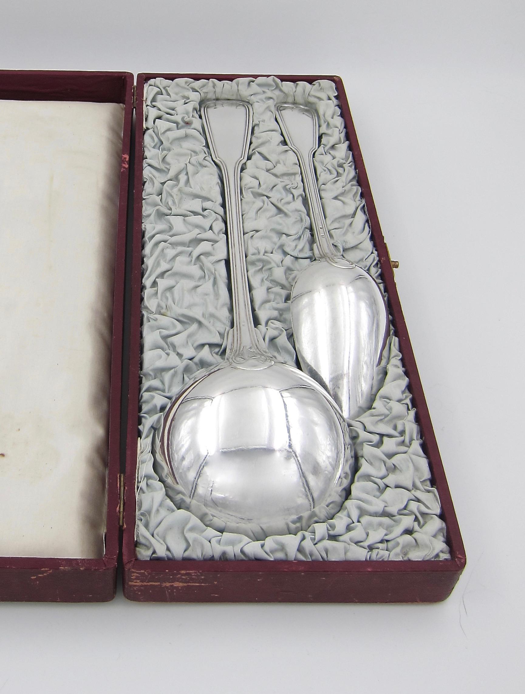 A large antique serving spoon and ladle in heavy silver plated metal Blanc (white metal) from Christofle of France. The French serving utensils were made in 1878 in Christofle's Chinon pattern, also called Fiddle and Thread. The pieces retain their