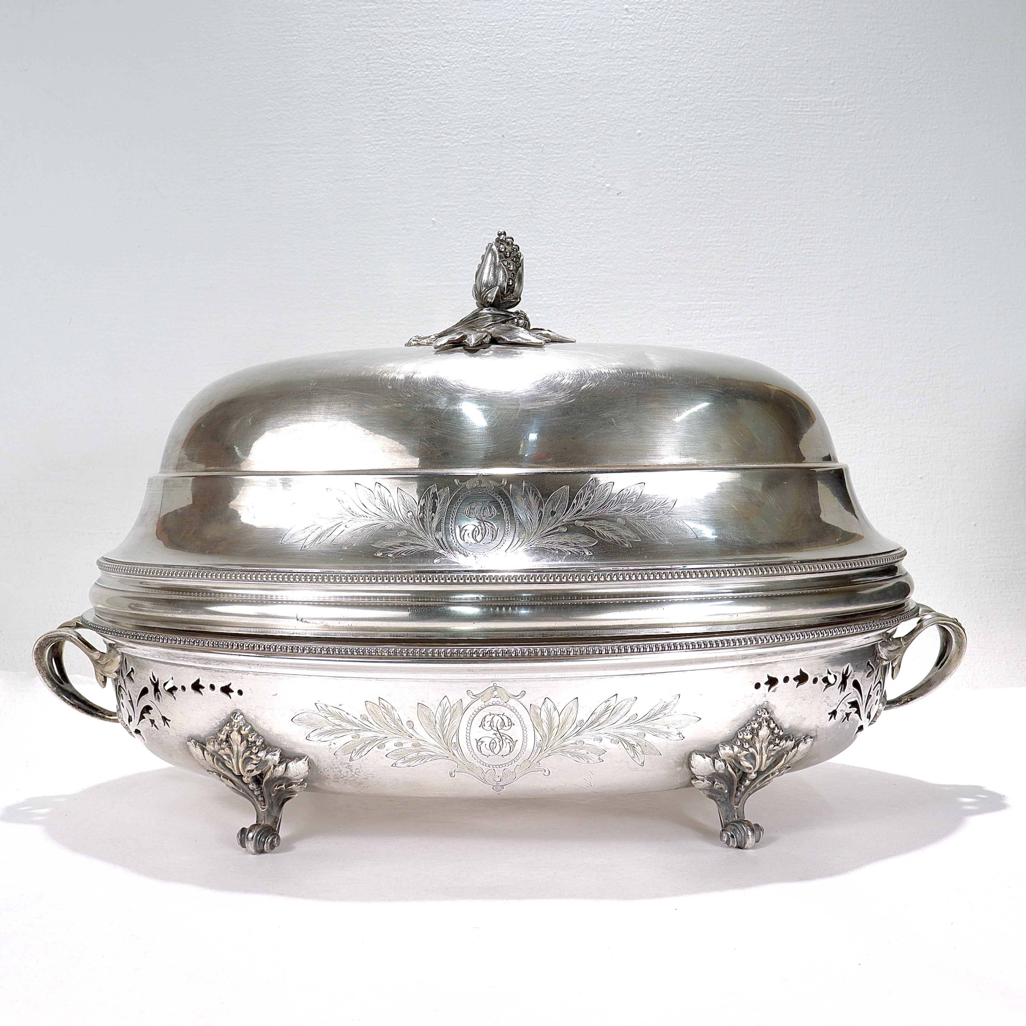A fine antique silver plated food warmer or tureen.

By Christofle et Cie.

Consisting of a two-part oval meat or fish warmer with scroll feet and acanthus leaf handles with a conforming dome or cover.

The cover has a flower or fruit finial.