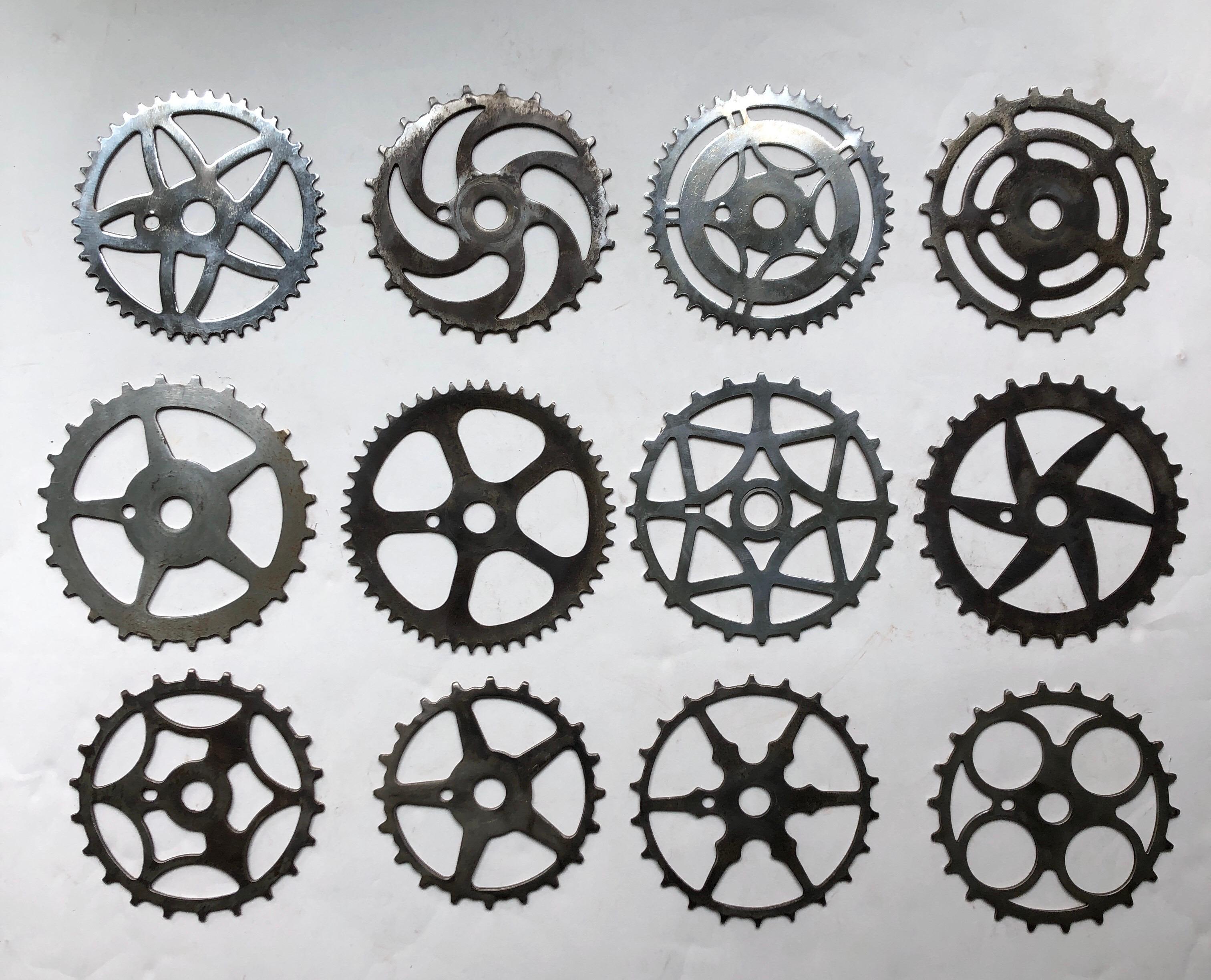 A collection of 12 antique and vintage chrome-plated steel bicycle sprockets. Chrome plating shows varying degrees of ware. Great display in multiple combinations. This collection ranges in diameter from 6.5