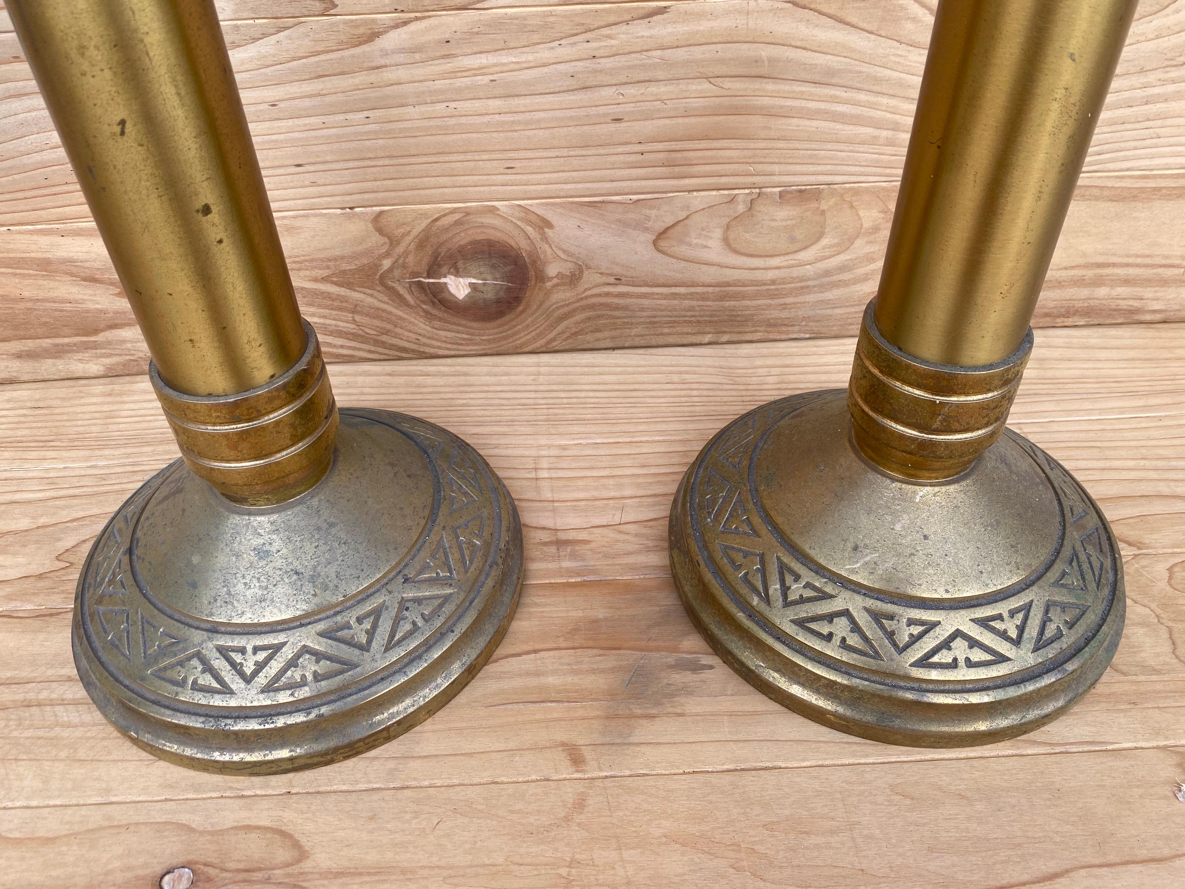 Antique Church Altar Floor Candle Holders

This pair of tall candleholders would be a sumptuous statement piece on your dining room table. The wax plates and bases of each stick have matching abstract triangle motifs. One candlestick has more patina