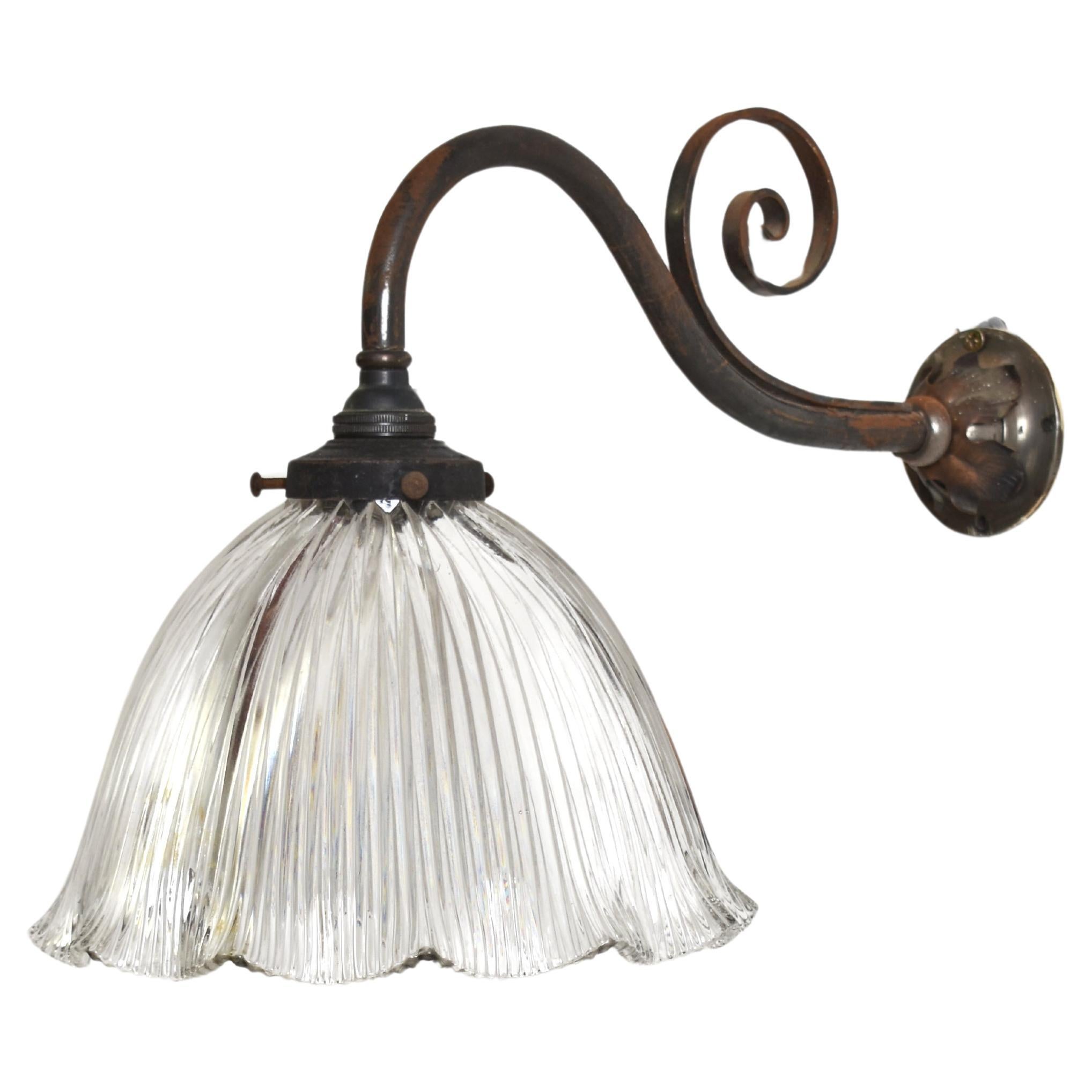 Antique Wall Light with Holophane Glass Shade

An original Holophane glass wall light with original wall bracket. The metalwork has been left in its original condition. These stiletto type glass pendants retain their original Holophane makers mark.