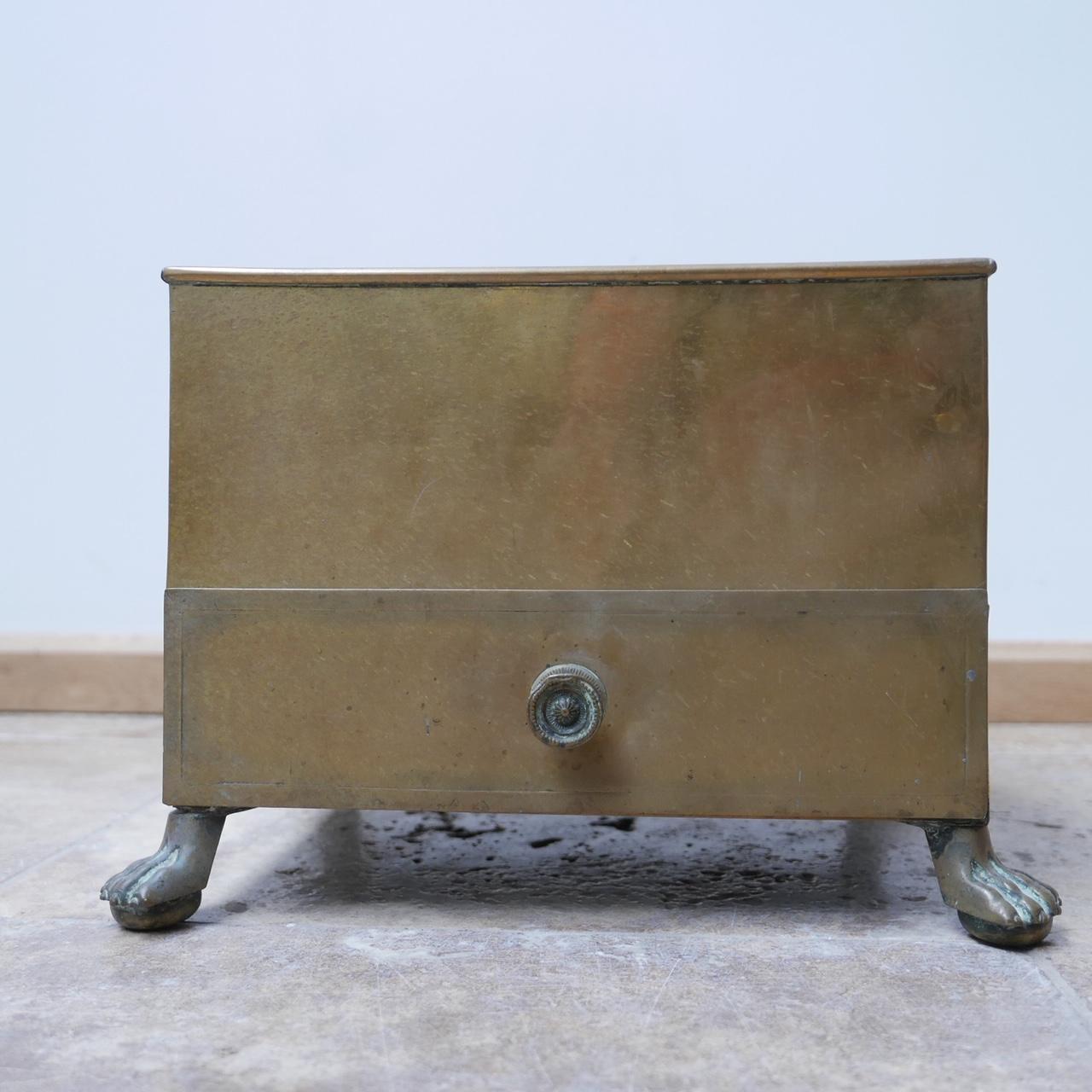 
ONE AVAILABLE
A rare cigar and cigarette ends bins.

Brass, with quality cast claw feet, and decorative detailing to the drawer pull.

The drawer removes completely making for easy cleaning.

Embossed brass label.

Likely from a quality hotel or