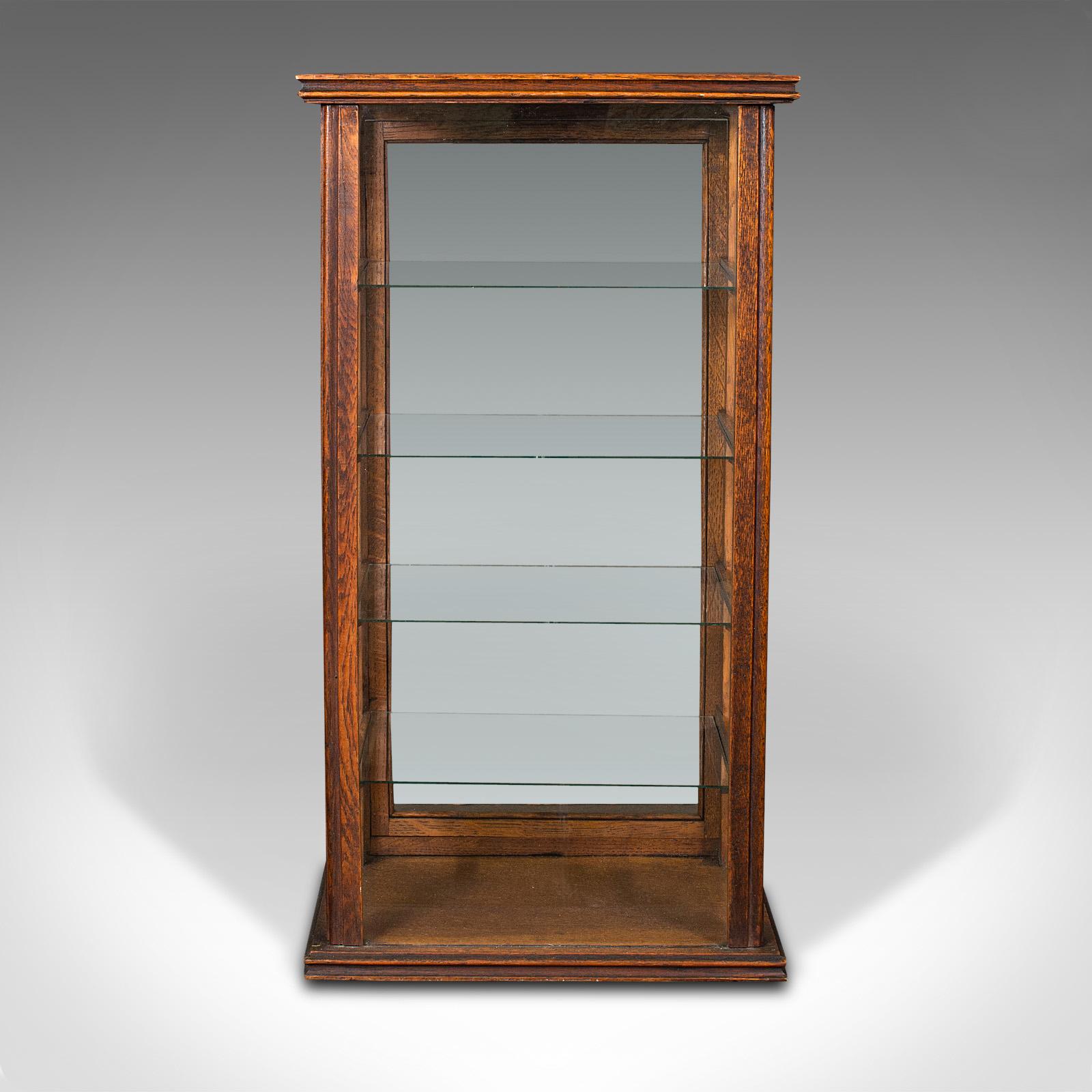 This is an antique cigar display cabinet. An English, oak retail countertop showcase, dating to the Edwardian period, circa 1910.

Compact and appealing glazed countertop cabinet
Displays a desirable aged patina and in good order
Select oak