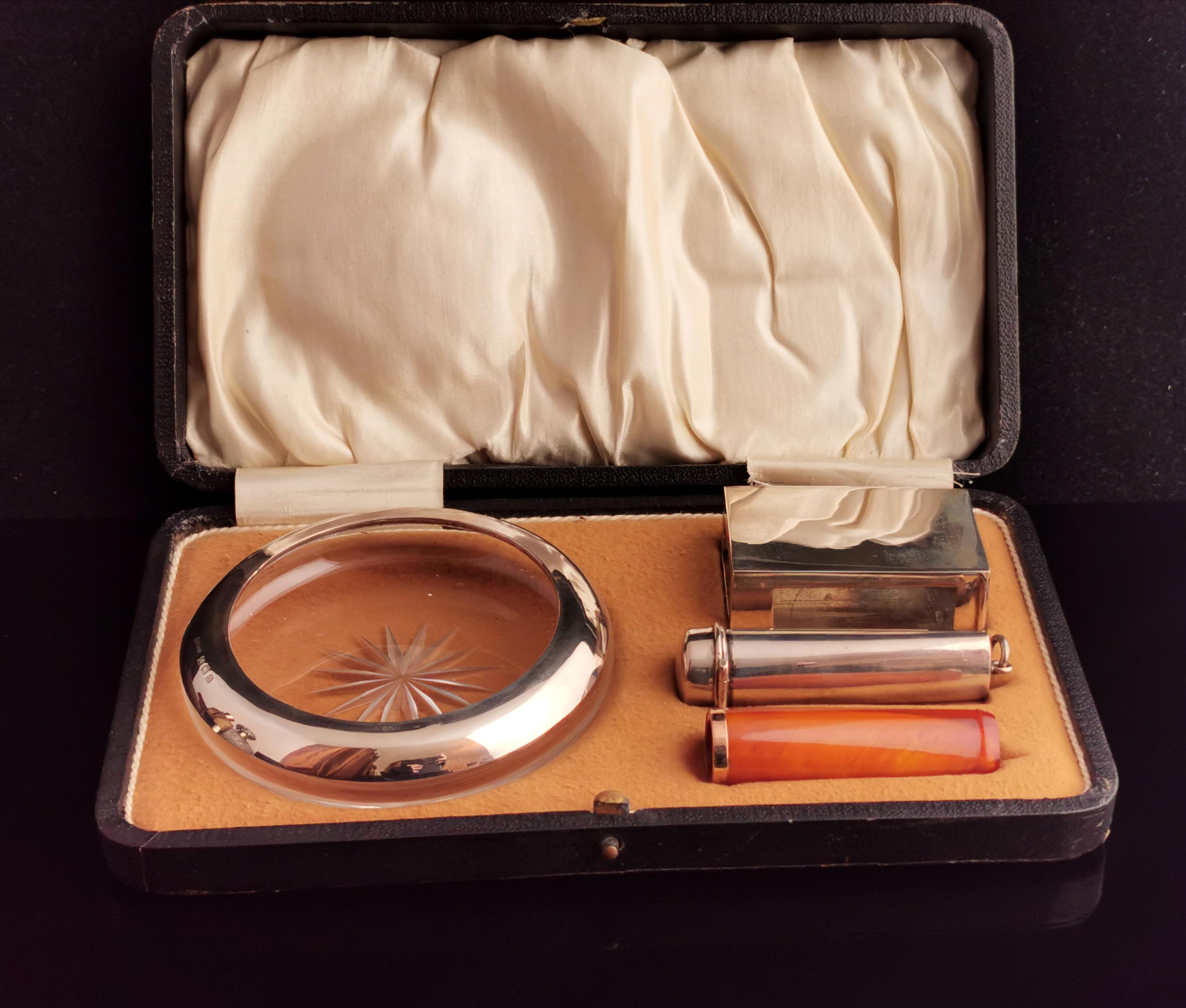 A stunning antique, early 1910s era, cigar smokers set.

The set consists of a cut glass ashtray with a sterling silver rim, starburst cut base, a fully hallmarked silver cheroot case with gilt lining.

There is a silver match box cover and an Amber