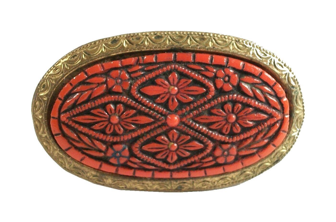 Antique brooch with carved cinnabar lacquer panel - tooled brass edge and back - c clasp and pin - unsigned - China - circa 1920's.

Excellent antique condition - no loss - no damage - no repairs - tarnishing of the brass trim from age and