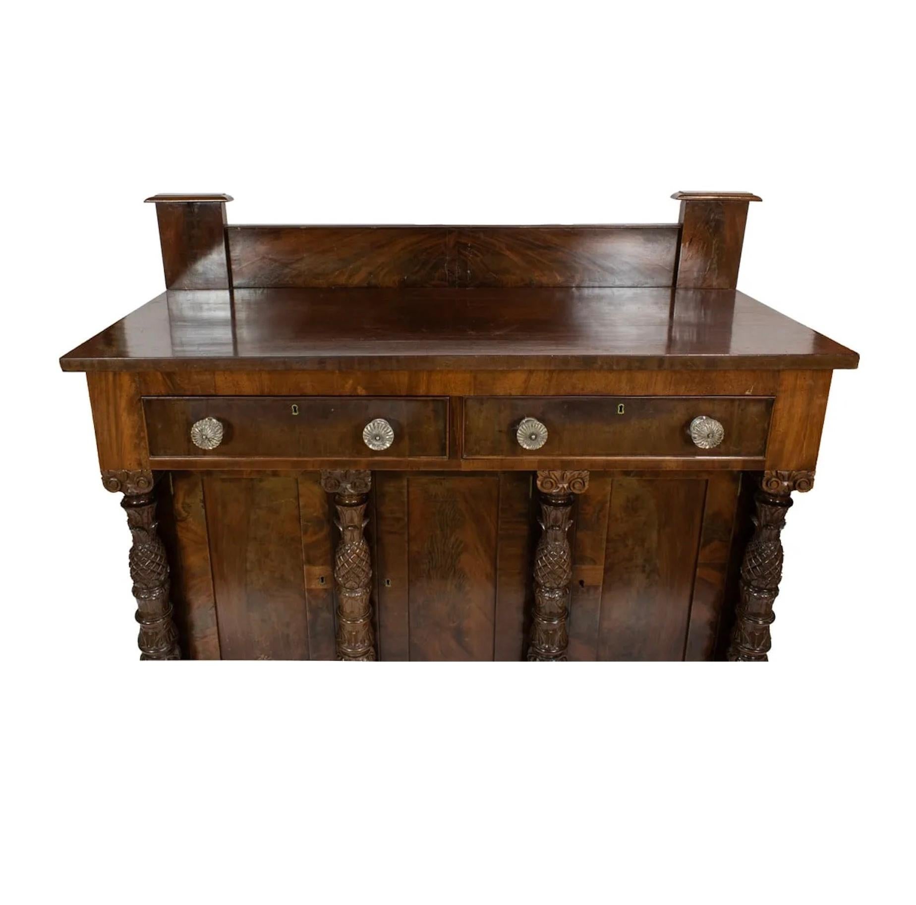 200 + Year Old Antique Circa 1800 American Federal Mahogany Sideboard in very good original condition with original glass pulls and original finish. The recessed back splash flanked by columnar form end supports, over the rectangular top, twin side