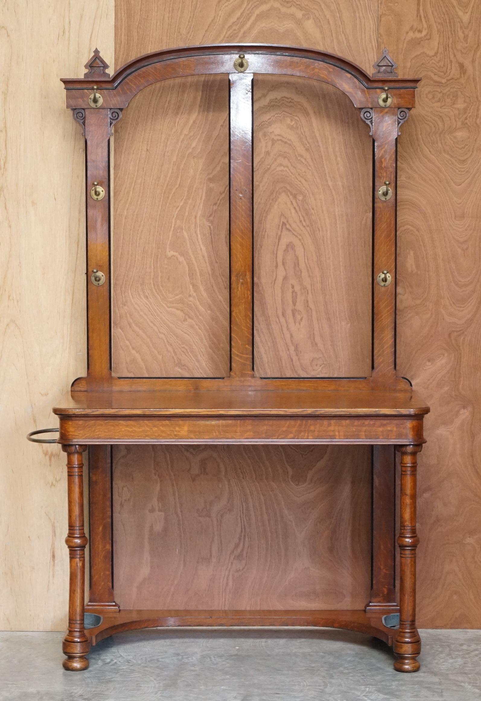 We are delighted to offer this very nice hand made in England circa 1830 William IV oak hall stand with bronze fixtures

A good looking and well made piece, it has a very Pugin look and feel to it, the pillared legs and finial tops look