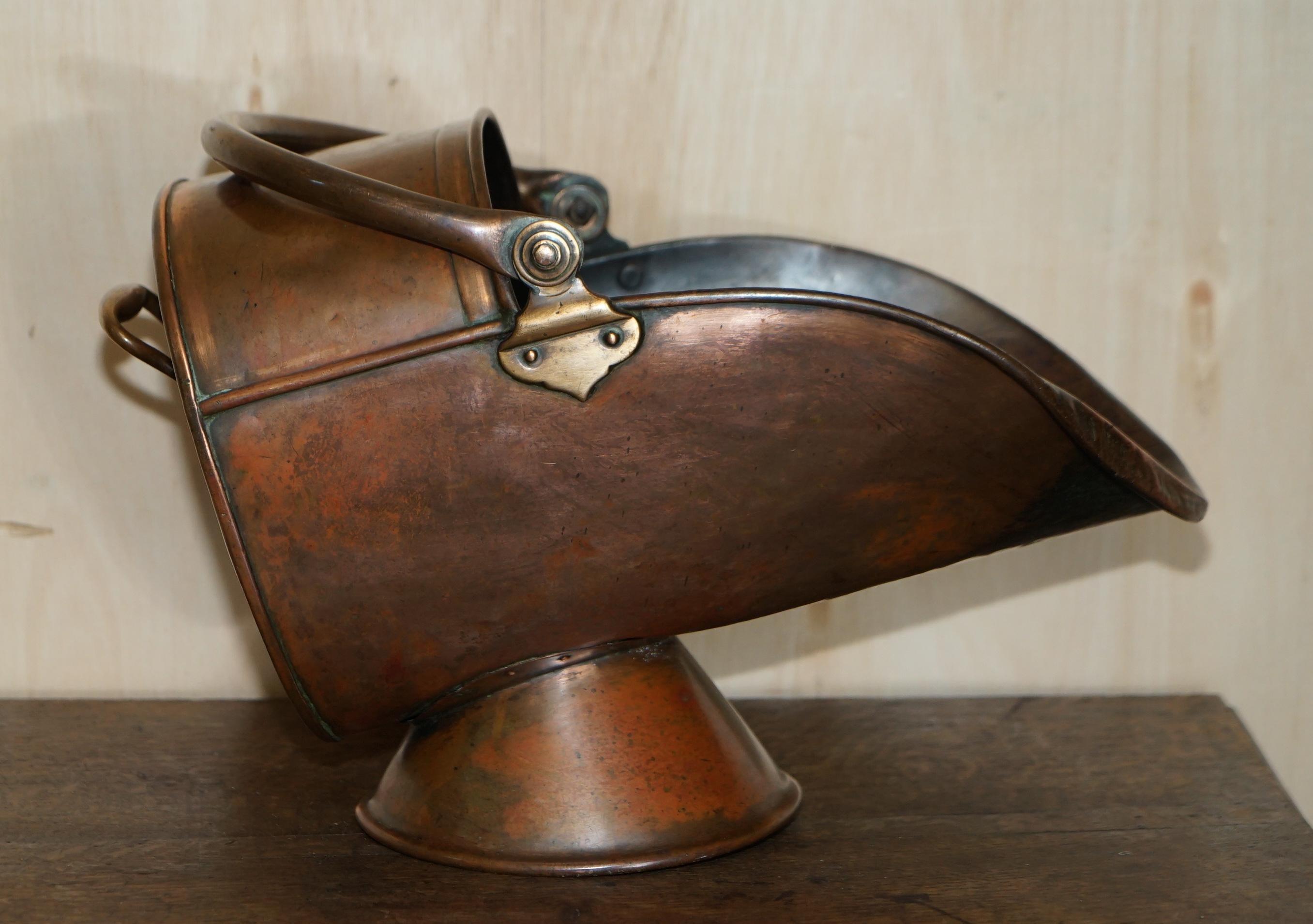 We are delighted to offer for sale this lovely original hand hammered English circa 1860 copper and brass coal scuttle.
This was called a helmet scuttle for obvious reasons, it looks like a Knights helmet. The body is made of hand hammered copper