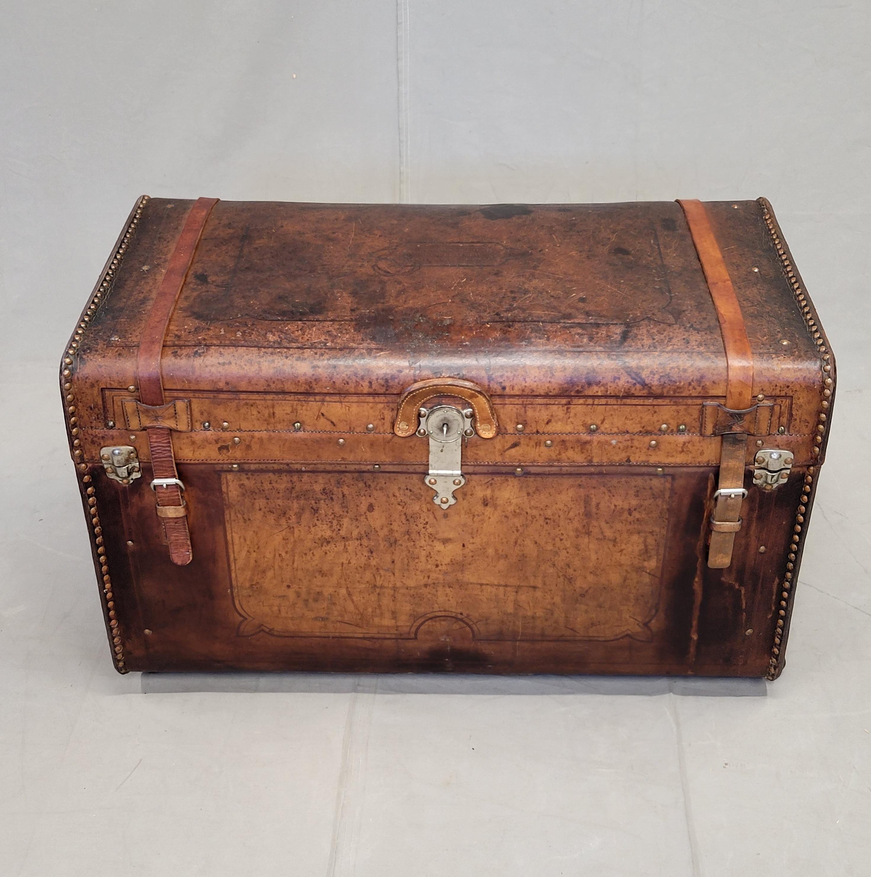 Antique circa 1875 leather clad western trunk Leather is abraded and stained from use, but this adds to the charm of this unique trunk. Trunk latches and locks with a key. The top of the trunk is stamped with 