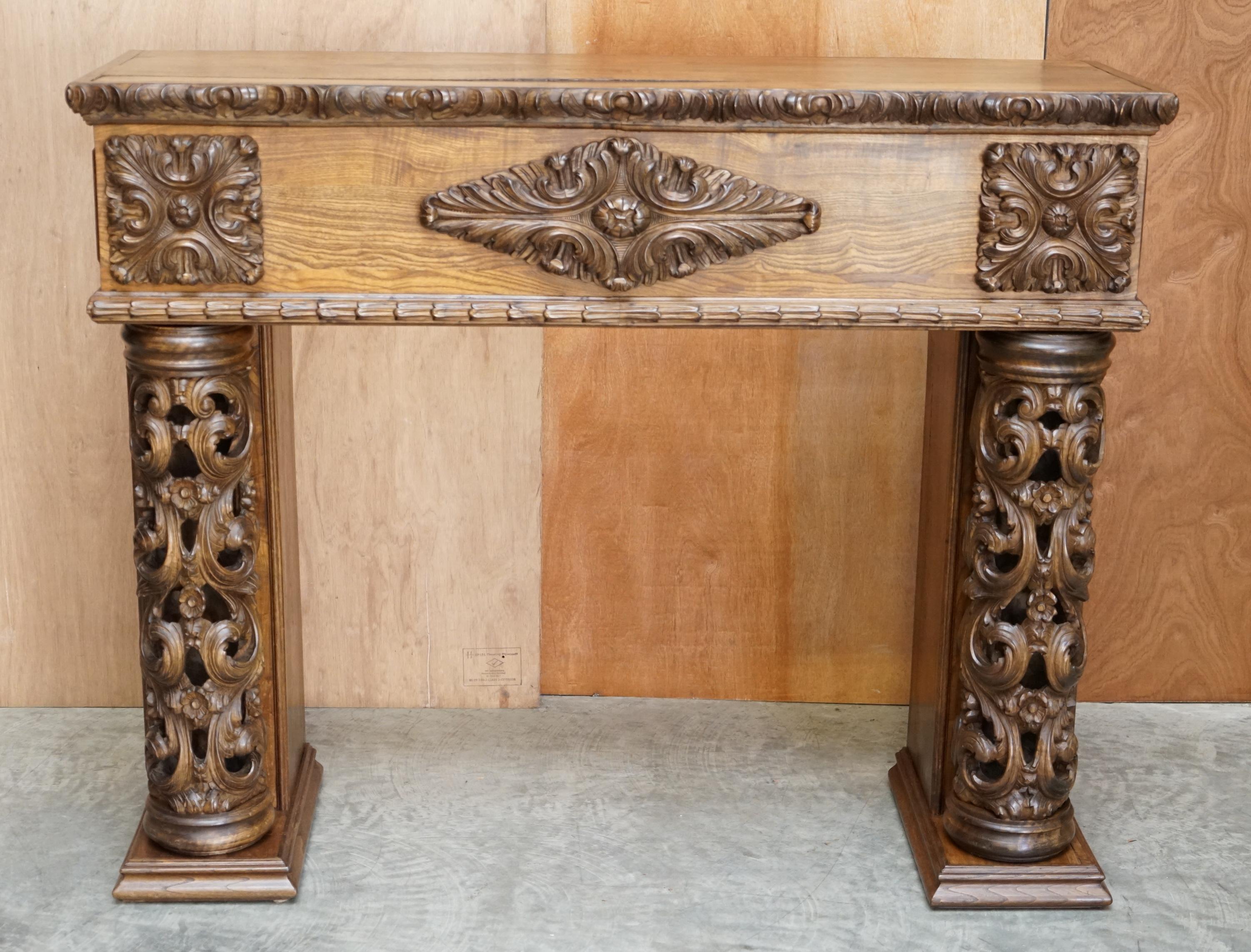 We are delighted to offer this stunning ornately carved solid Elm east European fireplace

A very good looking and well made piece. This came from central Germany, where it was originally made for, I don’t know, naturally it has come from one of