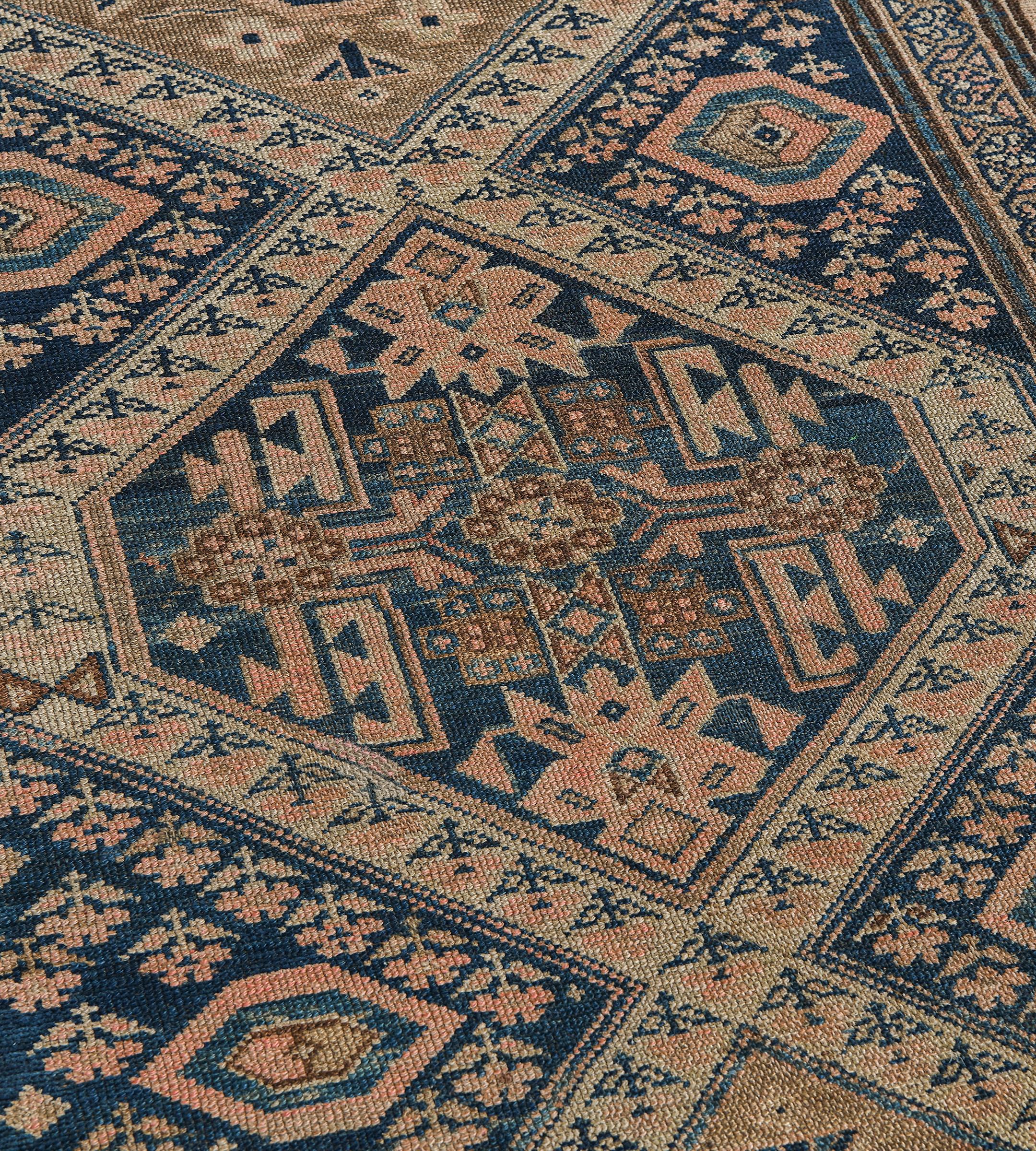 This antique, circa 1890, Persian Malayer runner has a field with a column of ten linked lozenges, the central lozenge with a shaded blue field with a central panel issuing angular floral vine, the others with a sandy-brown field and a central