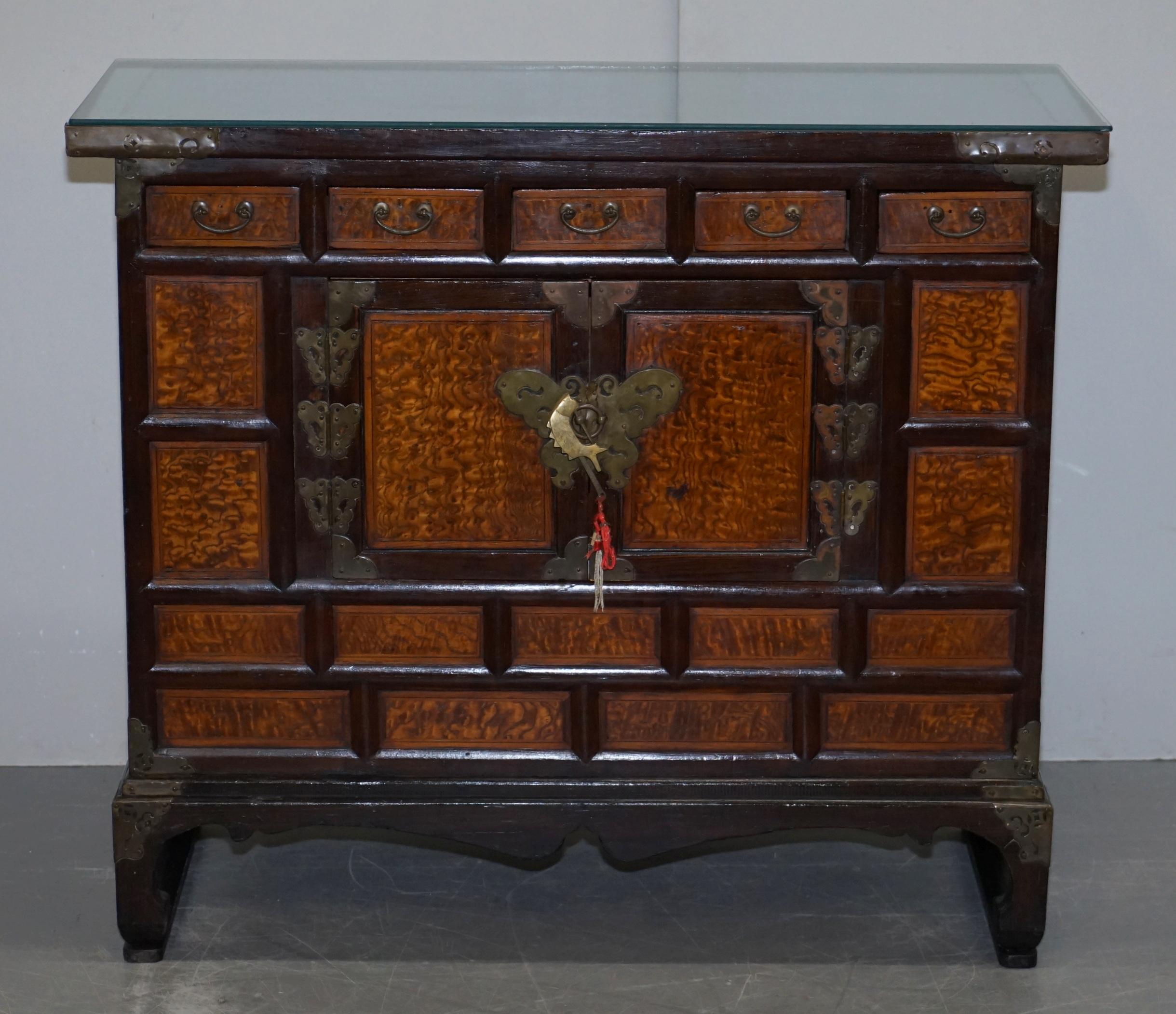 We are delighted to offer for sale this lovely circa 1900 Chinese Export burr elm sideboard

A very good looking and well made decorative antique piece, the timber patina is sublime, the hinges are all hand hammered and engraved butterfly’s which