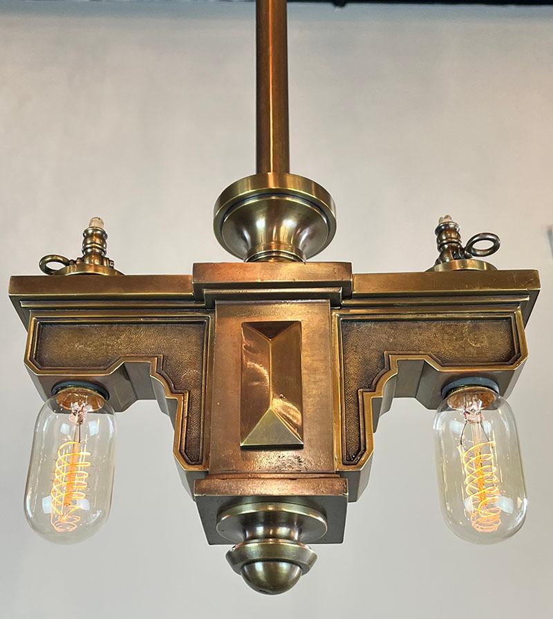 Rare early 1900s cast commercial bronze combination gas electric pendant. The quality on this light is incredible and it would have been in a prominent building like a bank or public building. Was originally a gas electric combination with the (now