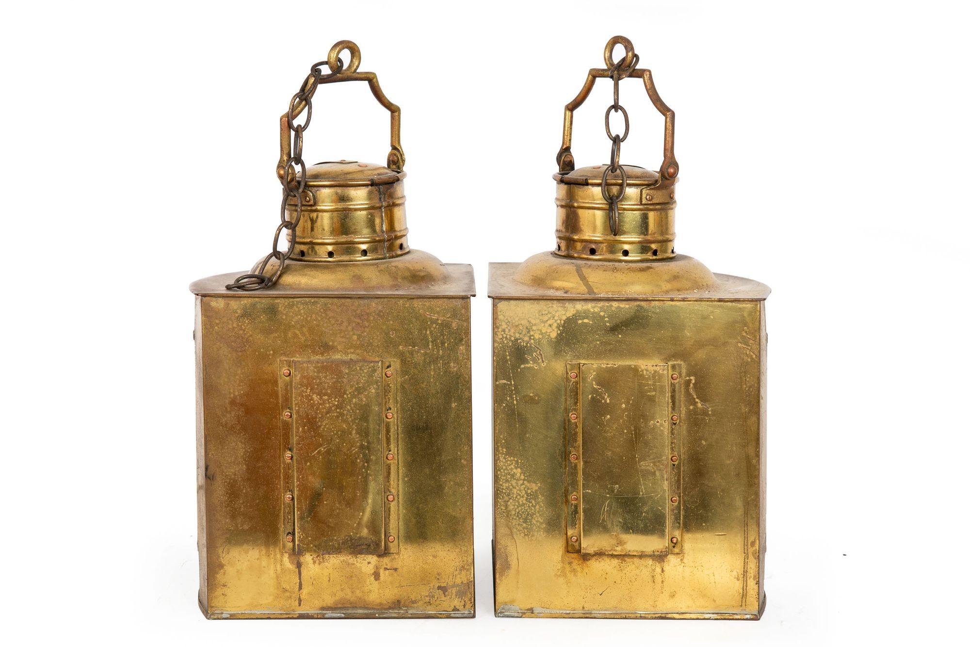 Pair of Antique Brass Ship's Lanterns
England, circa 1900

A wonderful aged pair of brass ship's lanterns with original red and green fresnel lenses from the turn of the century, each features a beautifully patinated body with extensive