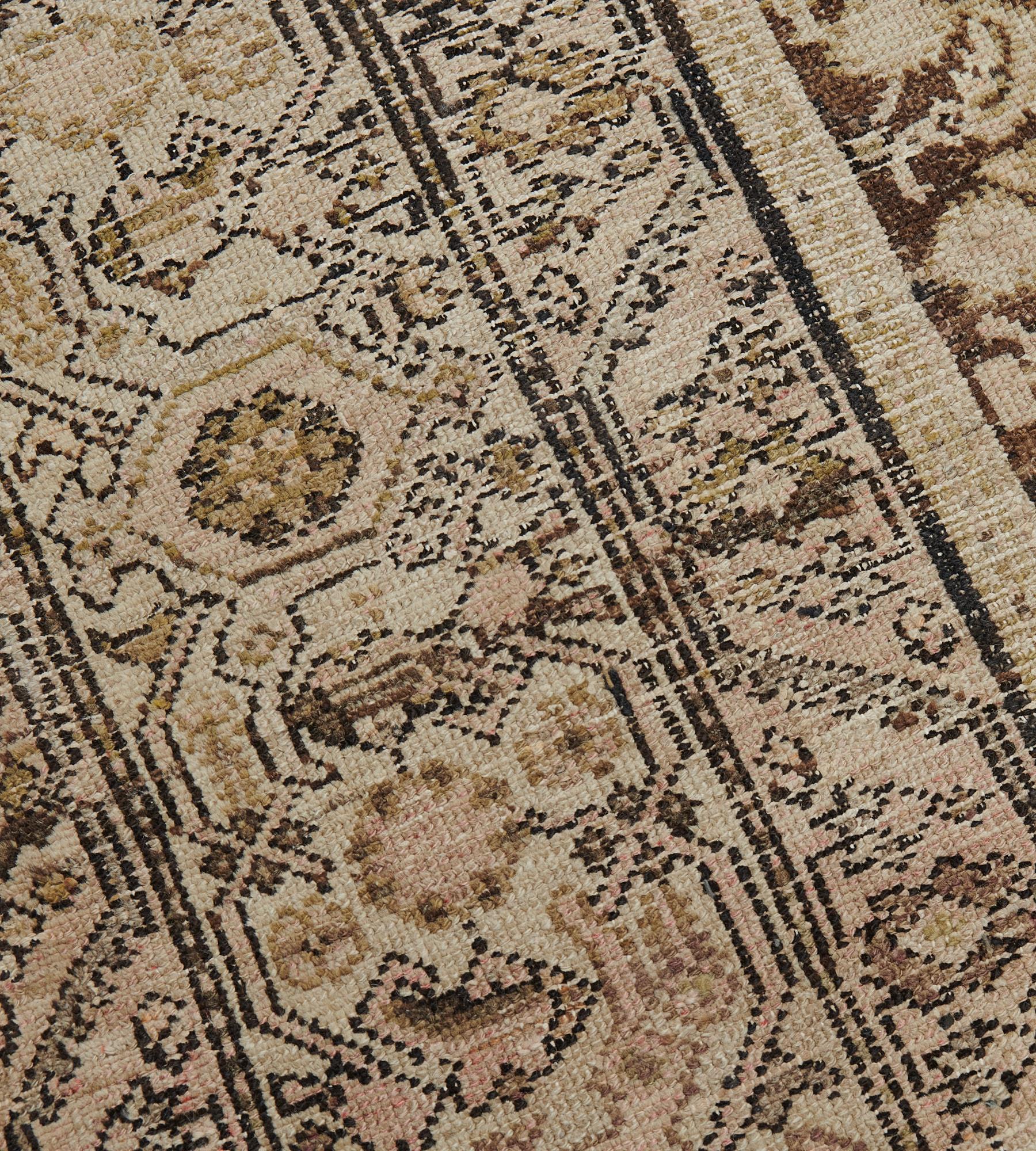 This antique, circa 1900, Malayer rug has a chocolate-brown field with an overall ivory, dusty-pink and pistachio-green herati-pattern, in an ivory border with pistachio-green, dusty-pink and chocolate-brown turtle-palmette and floral vine between