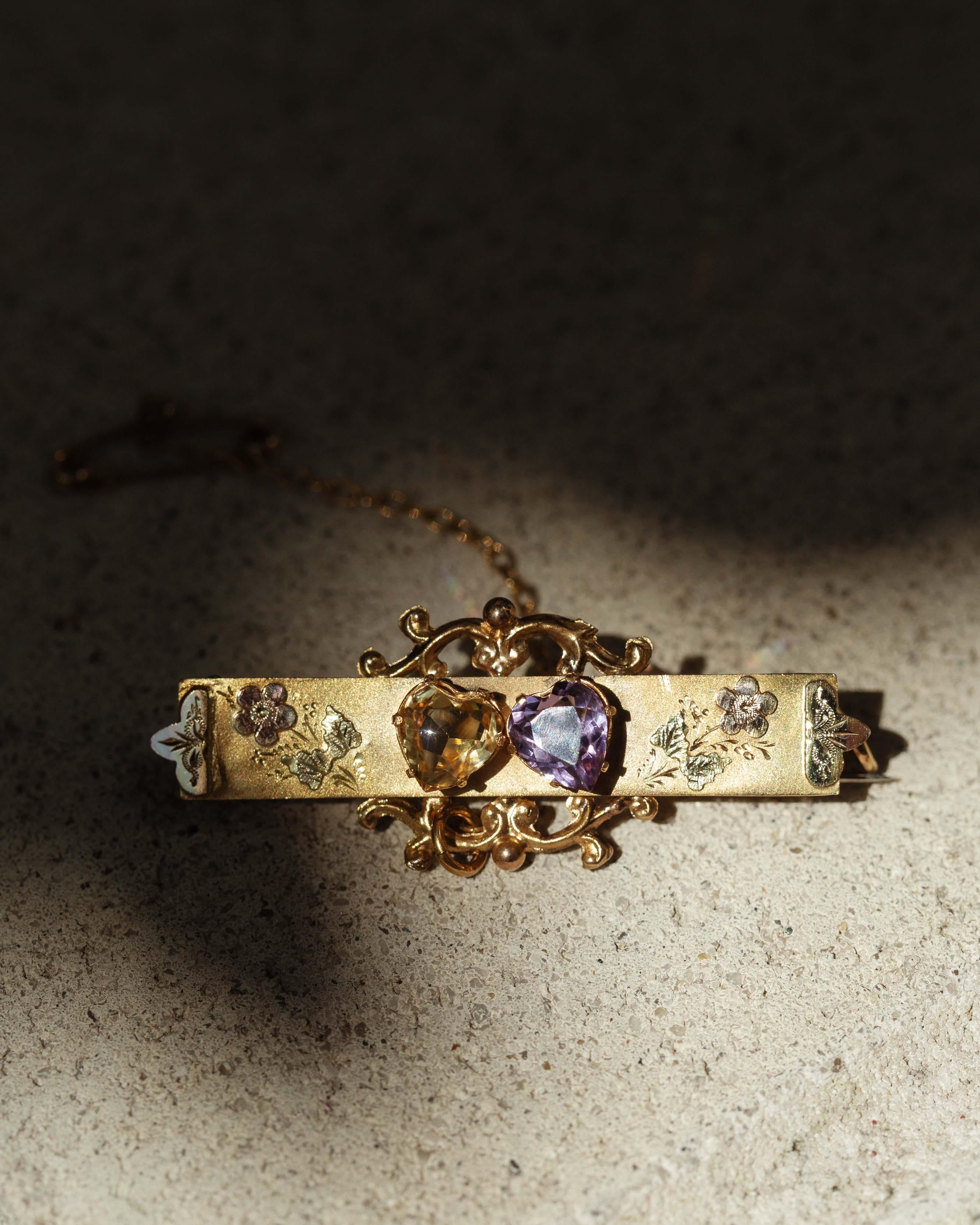 In the dance of light and shade, the Elvera Amethyst & Citrine Nature Brooch sings a story of warmth and transformation. Crafted in 9 carat yellow gold, vibrant gemstones reflect sunlight's kiss, evoking a sense of serenity and grace. Adorn your