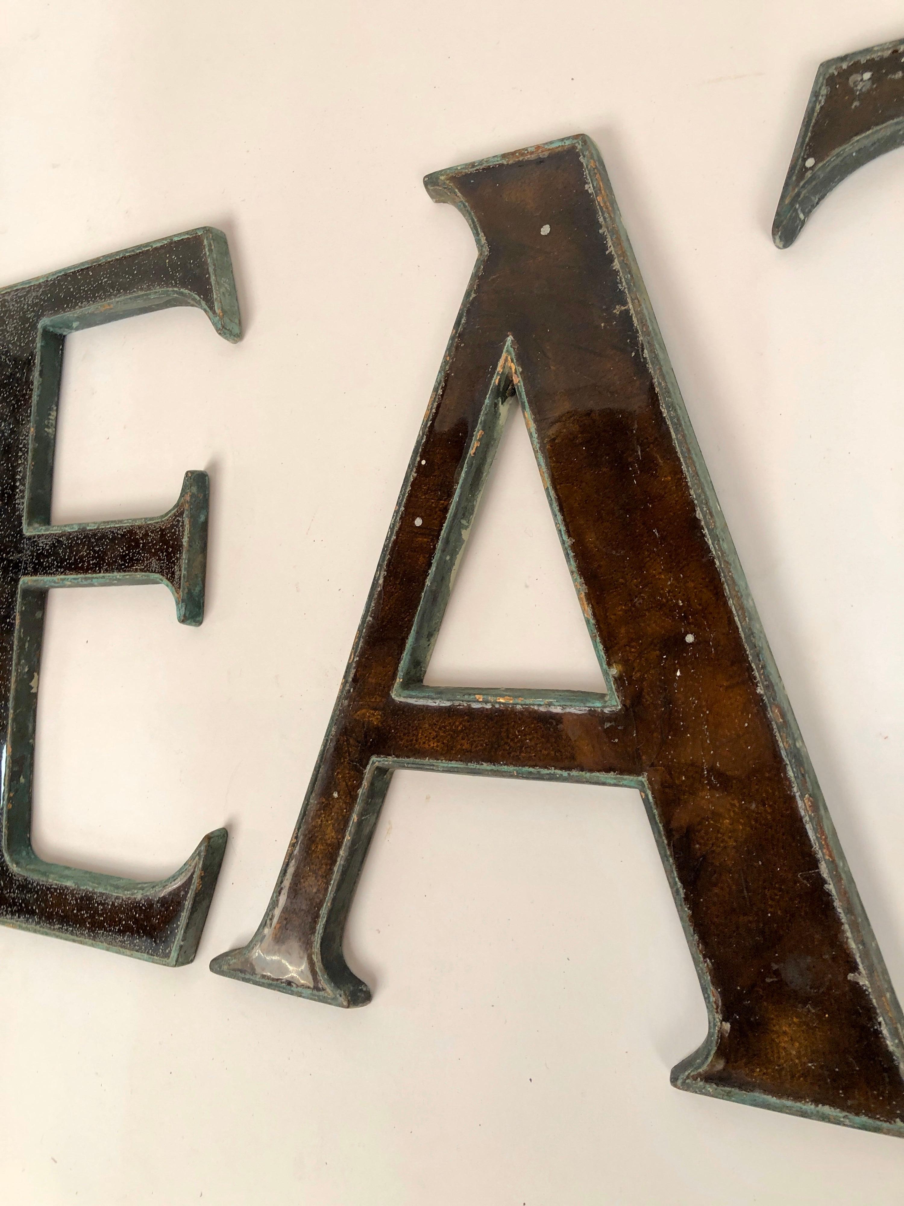 One of two sets of antique bronze and glass letters being made available from signs in London, circa 1910. This set spelling out 