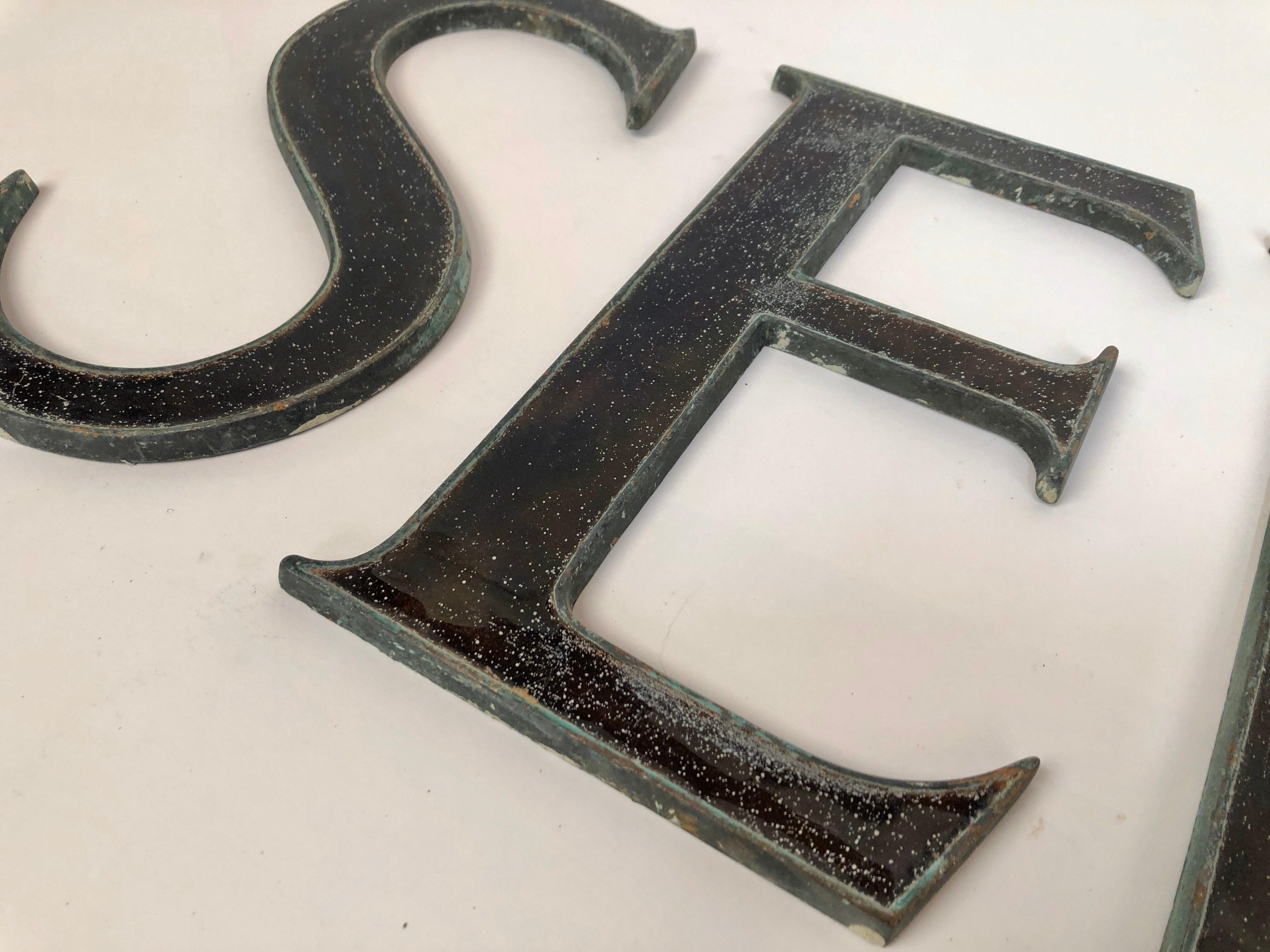 One of two sets of antique bronze and glass letters being made available from signs in London, circa 1910. This set spelling out 