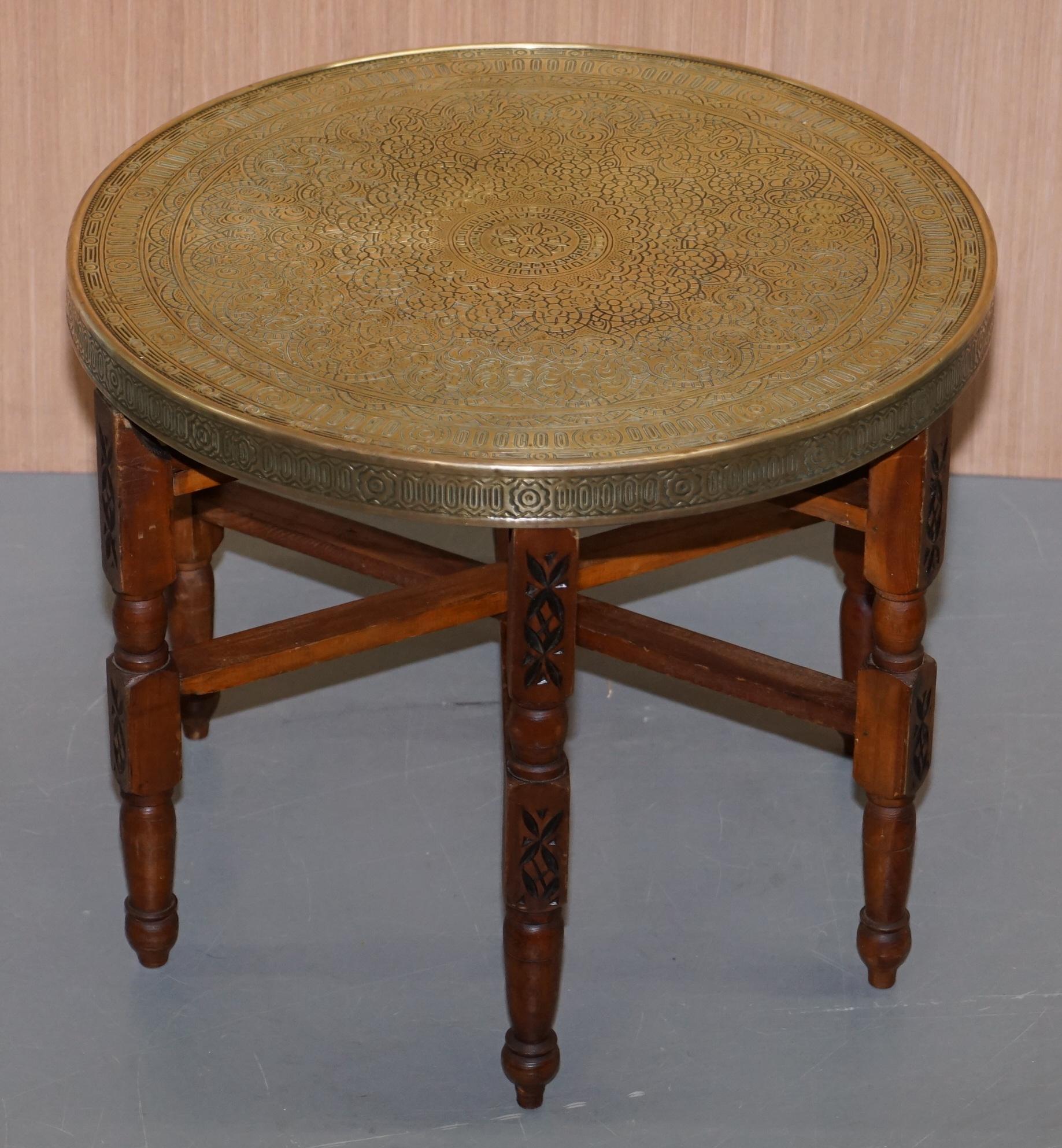 We are delighted to offer for sale this circa 1920-1940 Antique Persian Moroccan engraved brass top folding table with carved legs

A very good looking and well made table, the top is beautifully engraved by hand

We have lightly restored the