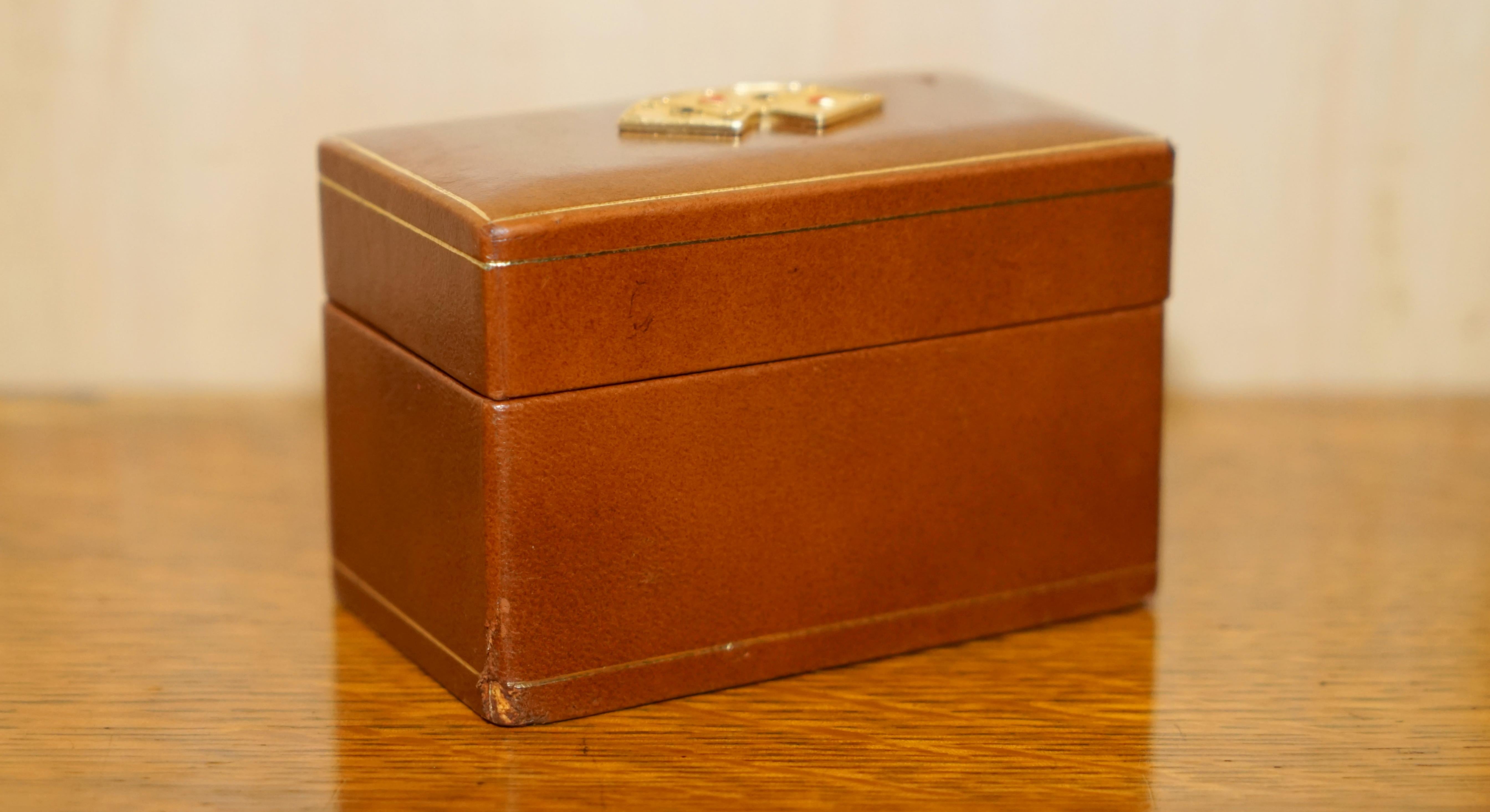 Royal House Antiques

Royal House Antiques is delighted to offer for sale this very nice and highly collectable Art Deco brown leather card case with brass cards plaque to the top and original cards inside 

A very good looking and decorative little