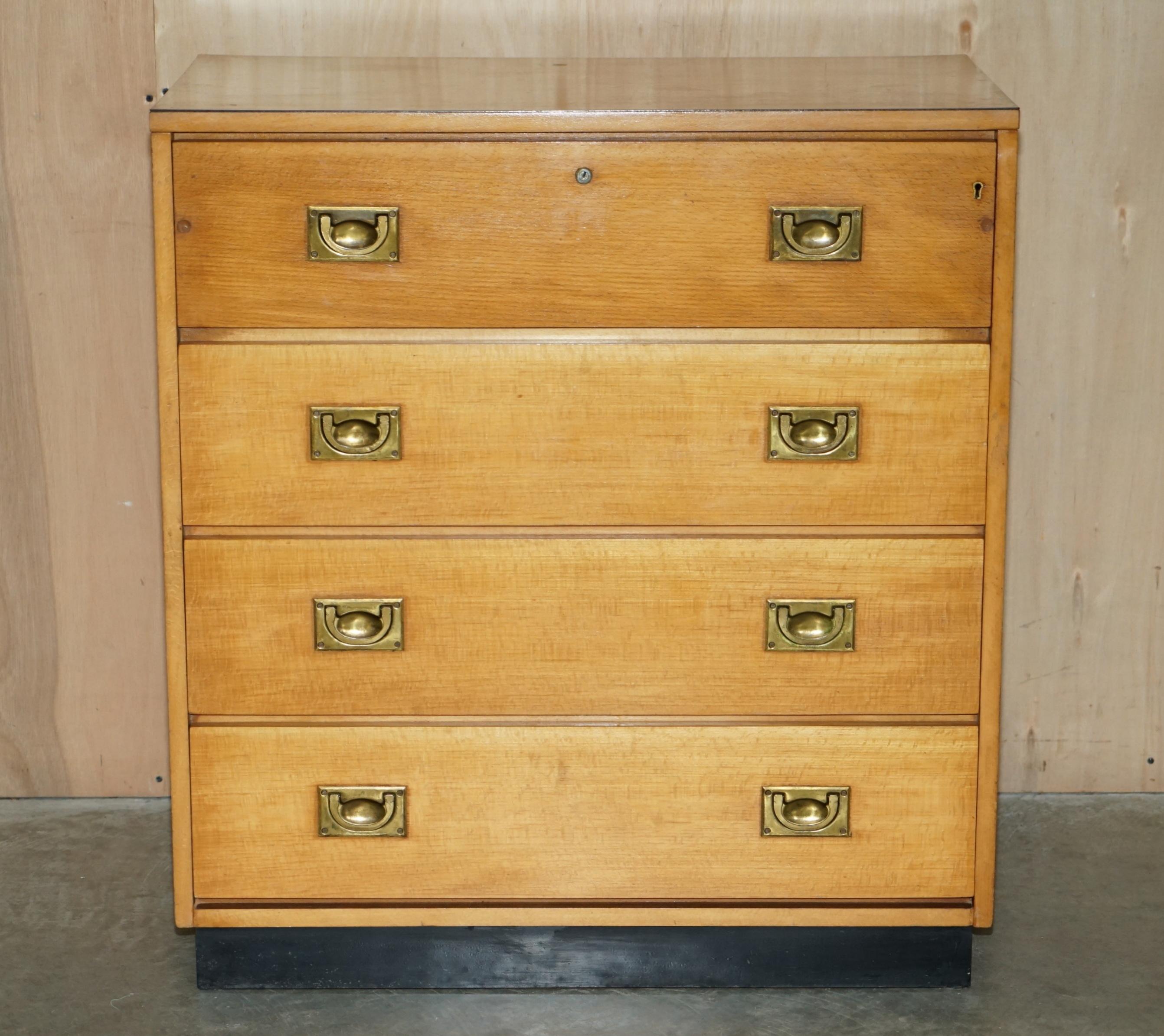 We are delighted to offer for sale this lovely circa 1920 Art Deco period English oak and brass Military Campaign chest of drawers with drop front top drawer.

This is a nicely made and utilitarian chest of drawers, the top drawer would have