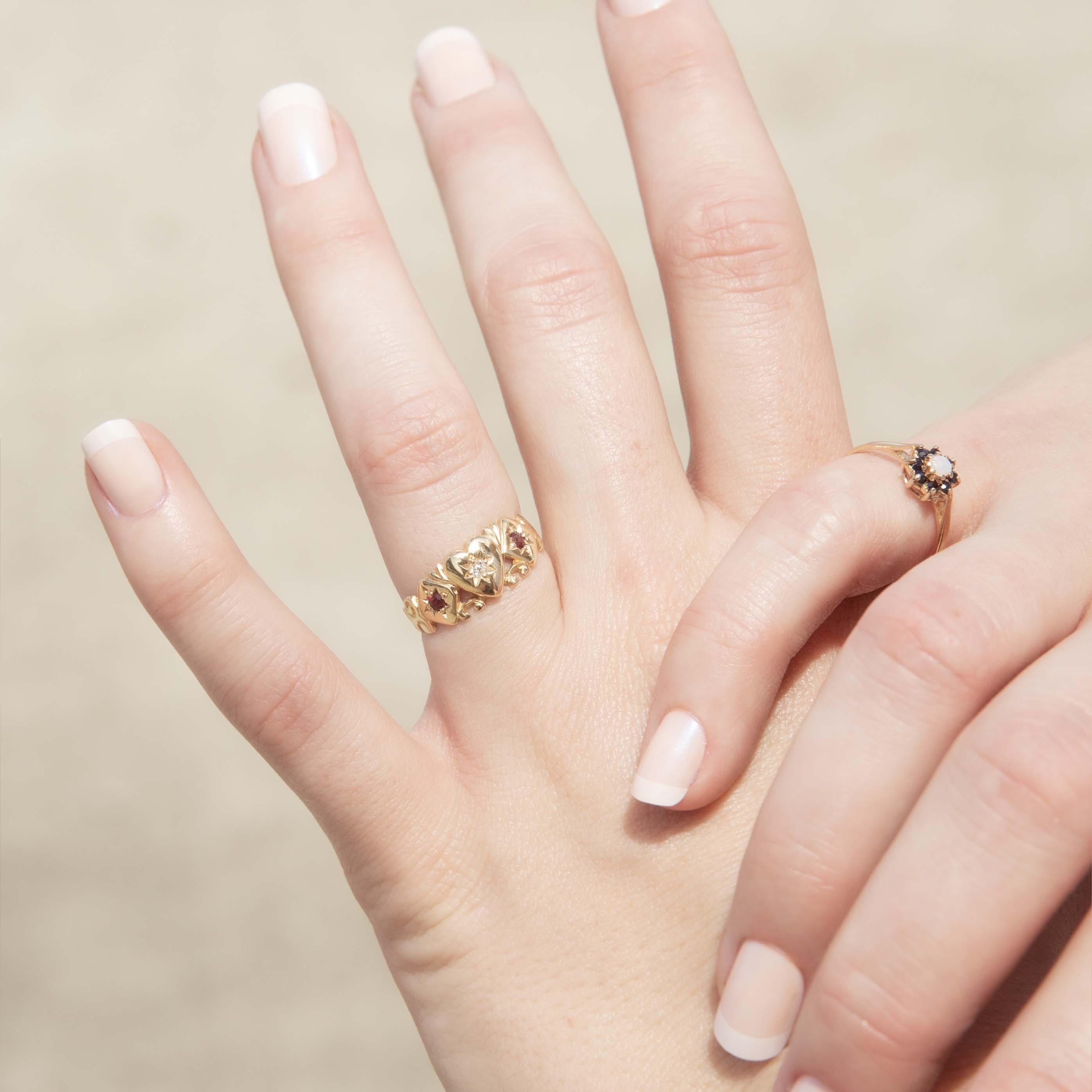 A romantic whisper from the past, our Lyanna diamond ruby signet ring in 15 carat gold speaks of love and devotion. A central heart, adorned with a sparkling diamond, is flanked by vibrant rubies. More than an adornment; she is a symbol of