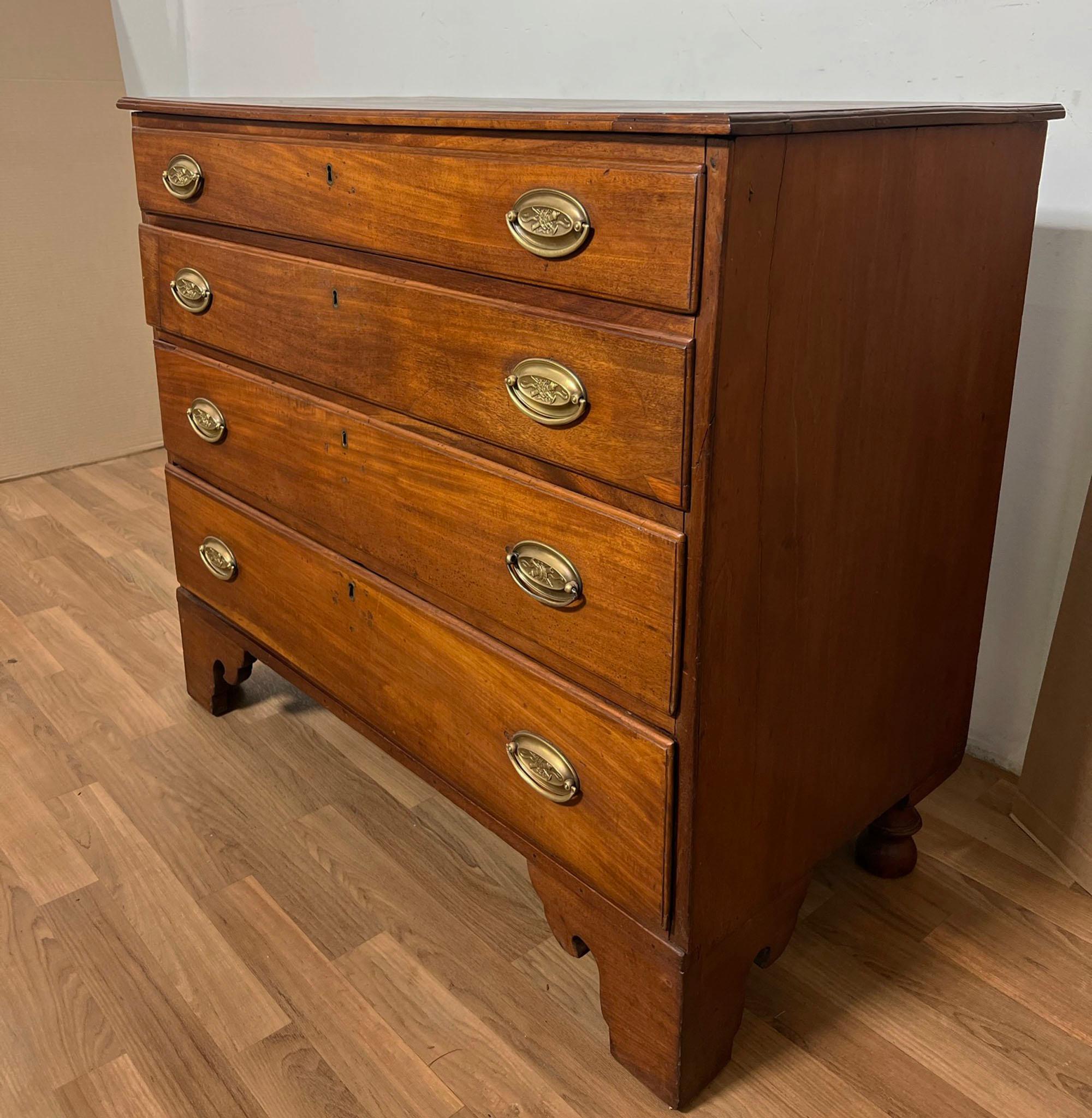 Antique American Federal period chest of four drawers in cherry over bracket feet.