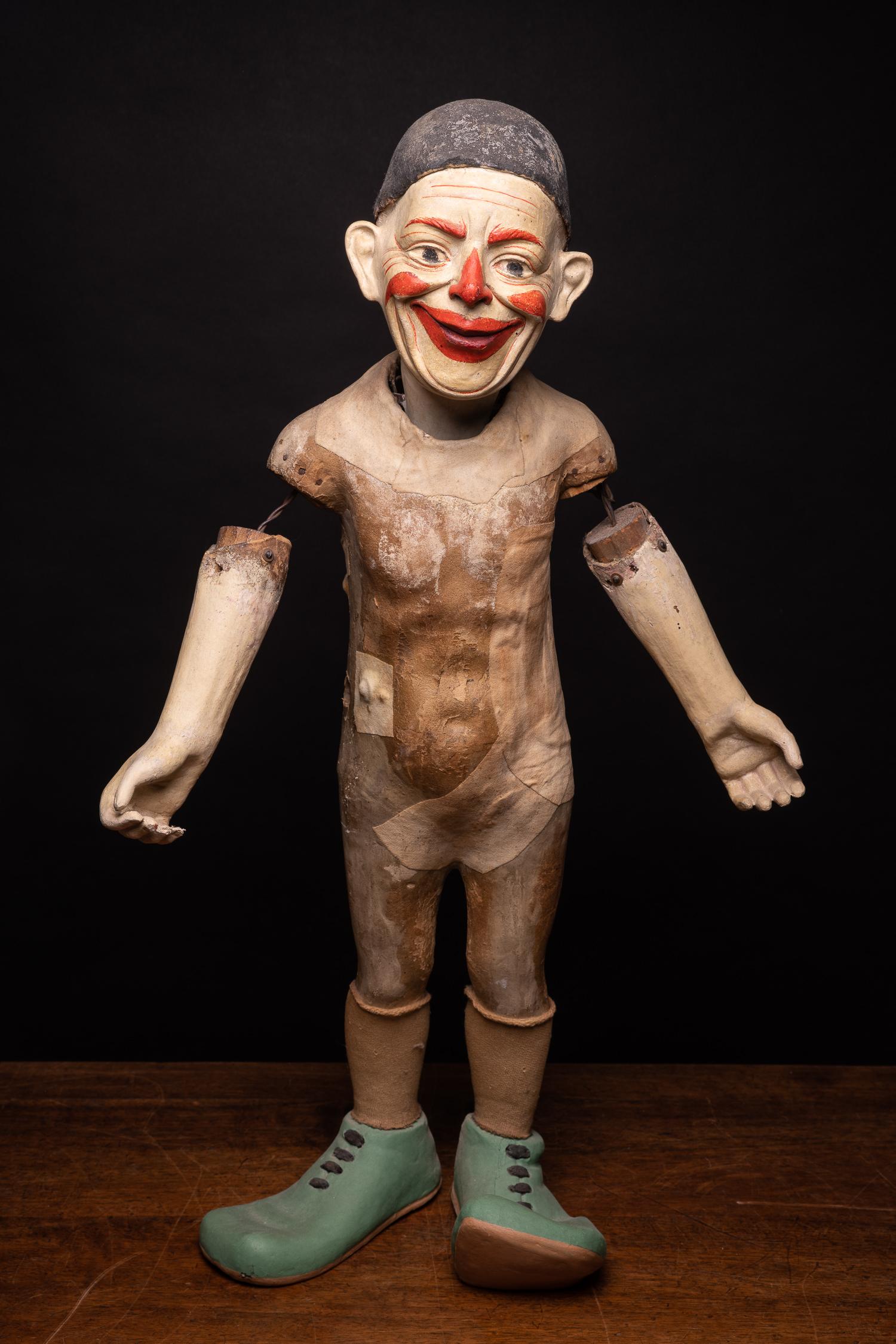 An intriguing example of a fully articulated circus puppet marionette, in the form of a clown. This figure is fully articulated with iron strings supports and stands on its own. His face is full of expression and effortlessly takes you to a playful