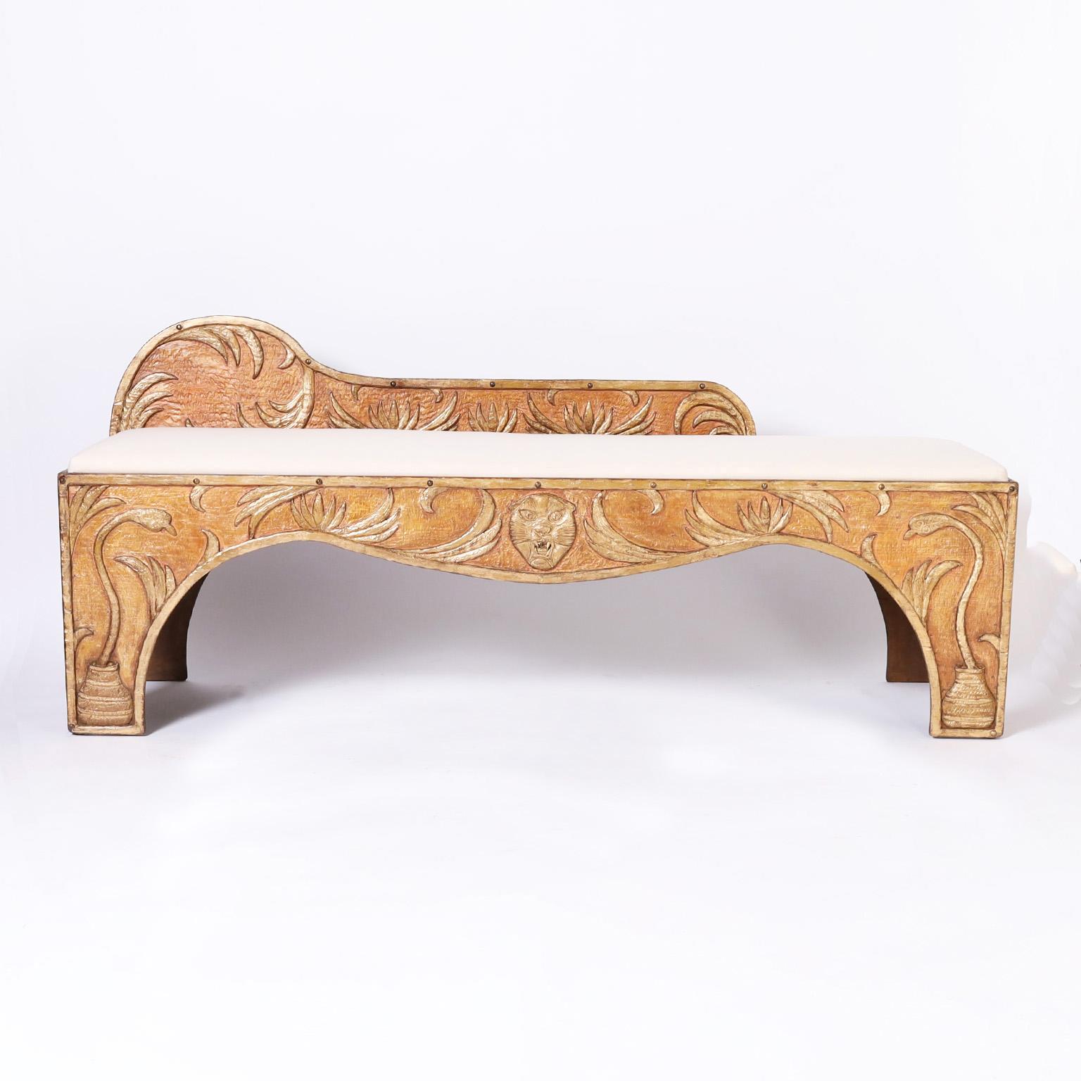Rare and remarkable bench or chaise lounge once used in a circus or carnival crafted in pine with dramatic carvings of snakes in a basket in a floral field with a cat head medallion, retaining its original paint and gilt finish. The back is hinged