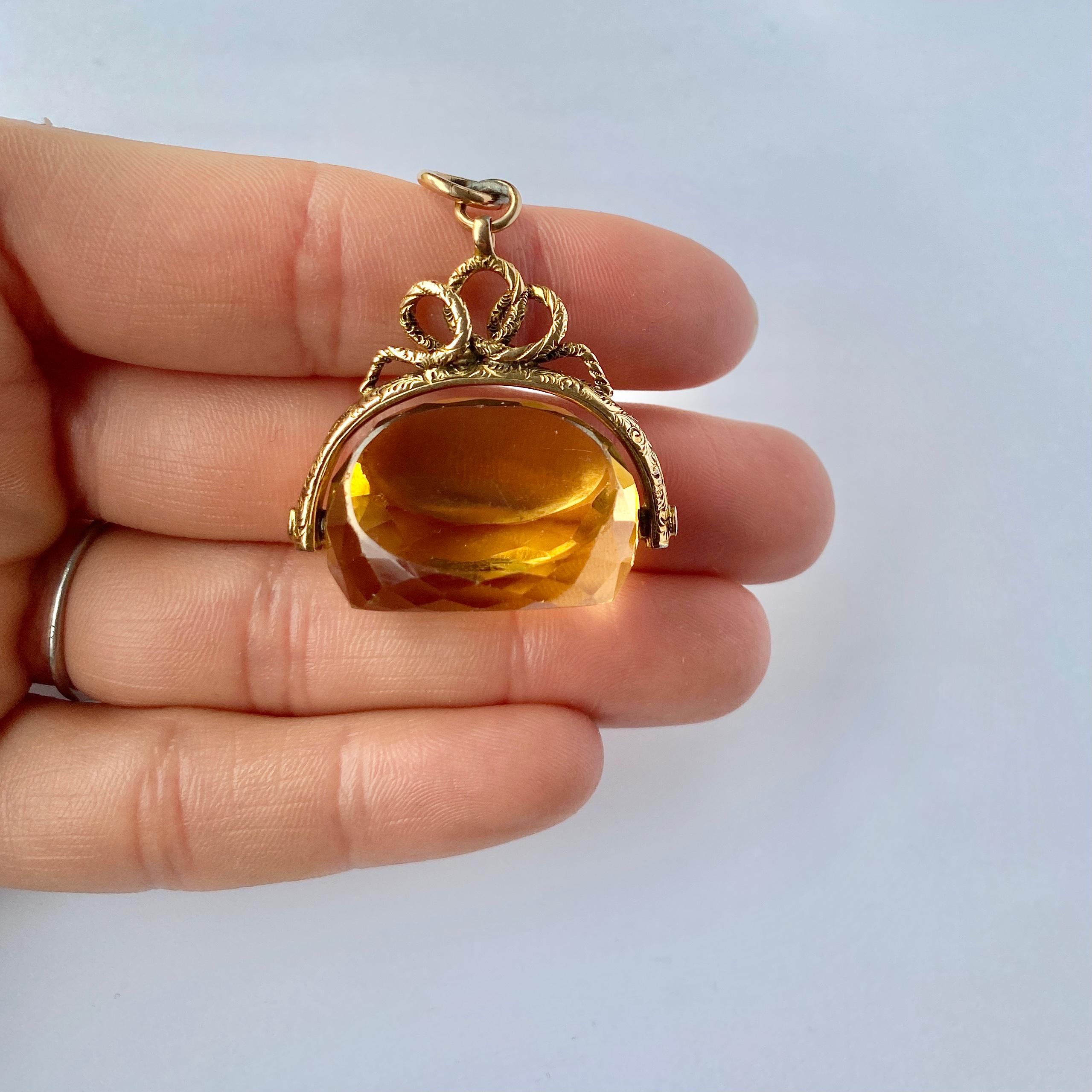 This gorgeous swivel fob holds a yellow citrine stone and the frame and loop is modelled out of 15ct gold. The frame has a snake like feel to it and twists and turns. 

Height including Loop: 45mm

Weight: 15.2g 