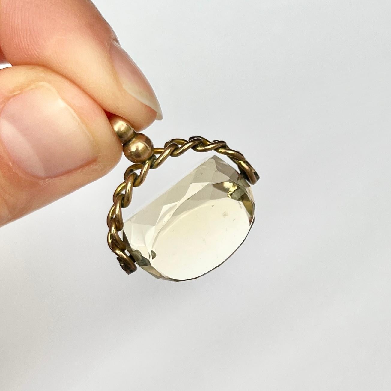 This gorgeous swivel fob holds a yellow citrine stone and the frame and loop is modelled out of 9ct gold. The frame has a chain feel to it and twists and turns. 

Height including Loop: 26mm
Stone Width: 19mm

Weight: 6.5g 