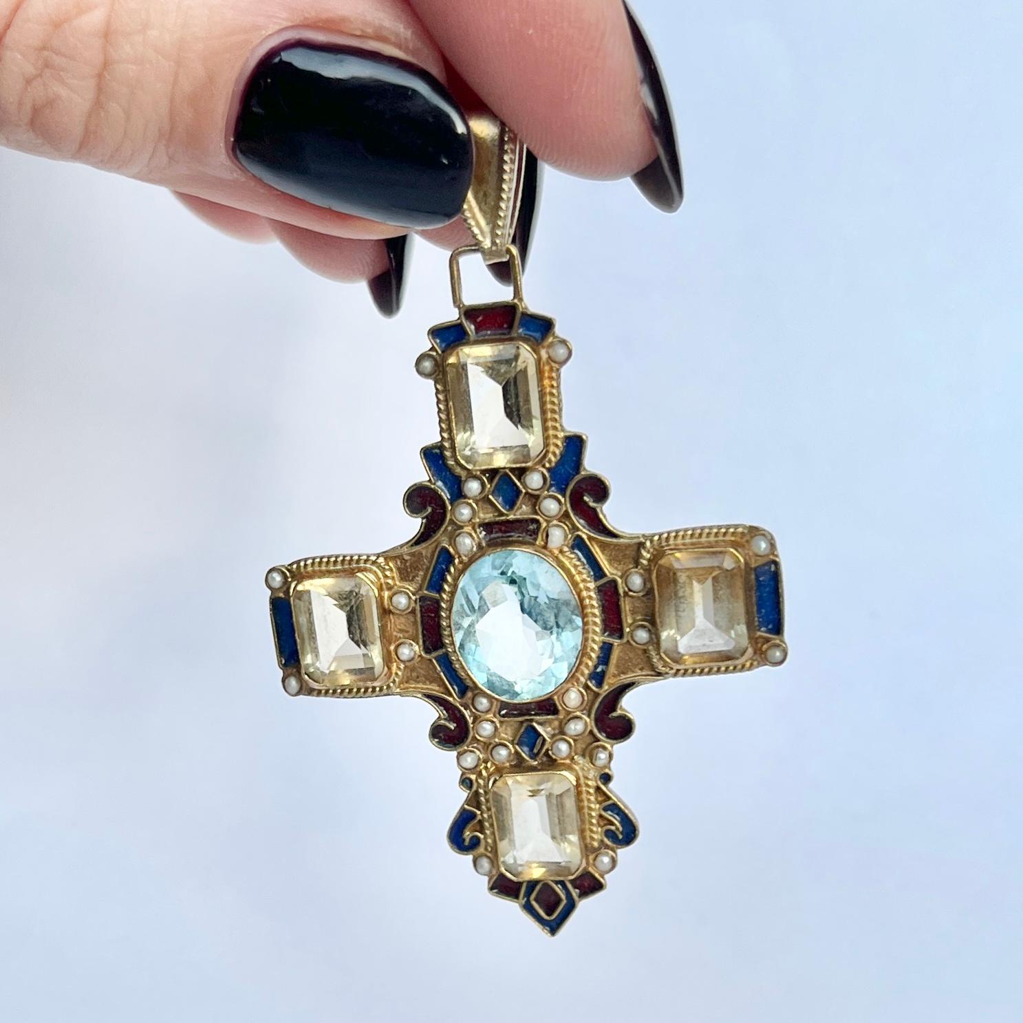 The stones in this lovely pendant are Citrine and the central stone and pale blue. There are also seed pearls set within the pinchbeck and enamel details. Pinchbeck is a metal used to mimic gold. 

Cross Dimensions (including loop): 35x58mm

Weight: