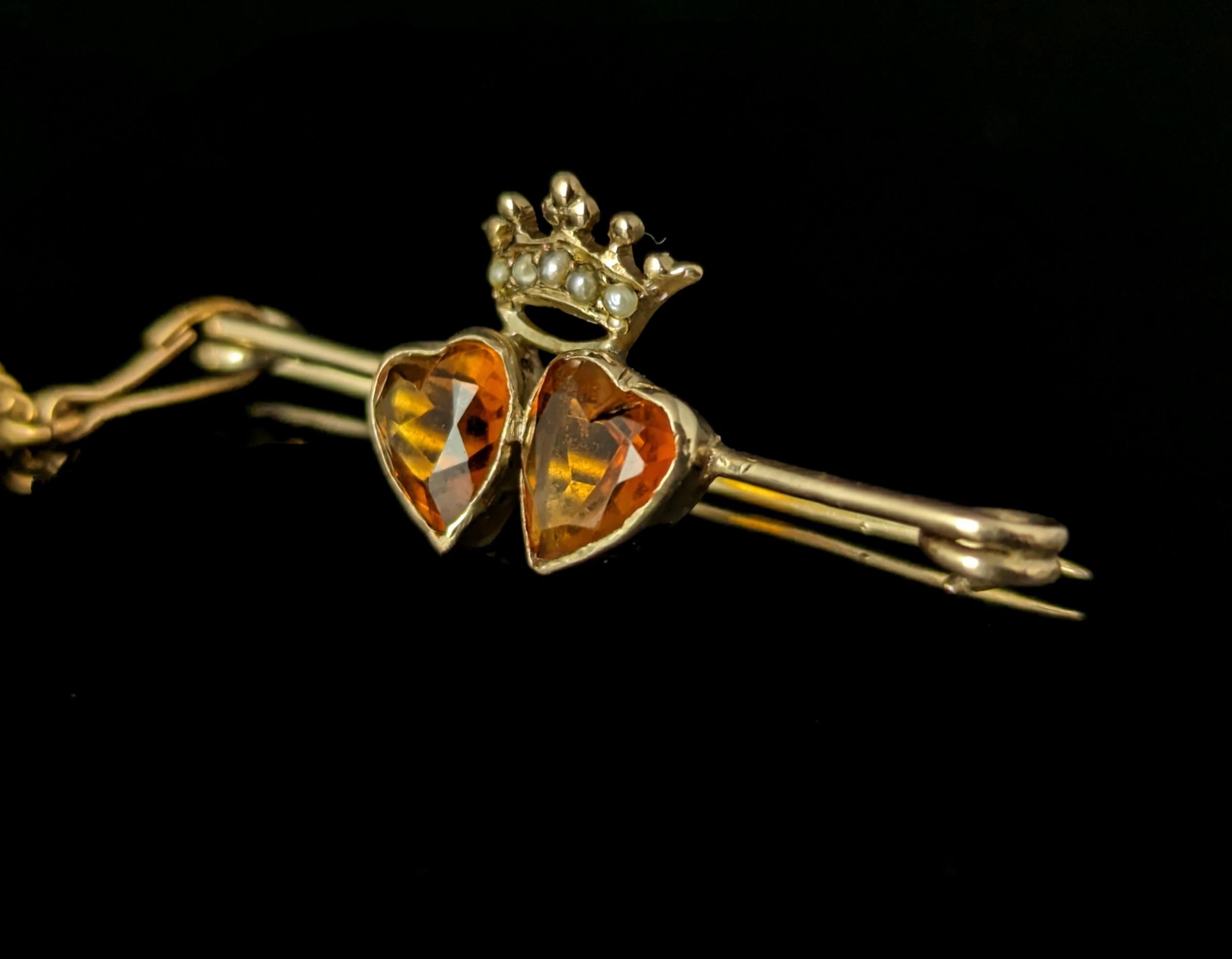 The sweetest little antique Citrine and seed pearl crowned hearts brooch in 9ct gold.

The crowned hearts were a strong and powerful symbol of love between two people and fidelity or their passion and devotion for each other reigning their