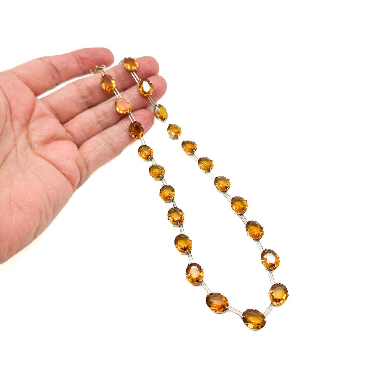 An Antique Citrine Paste Riviere Necklace. Gorgeous citrine pastes sit in gilded sterling silver mounts in a line formation creating a Rivière effect. A total classic yet totally en trend. Stacked or alone this beauty is a must have.
Rivière refers