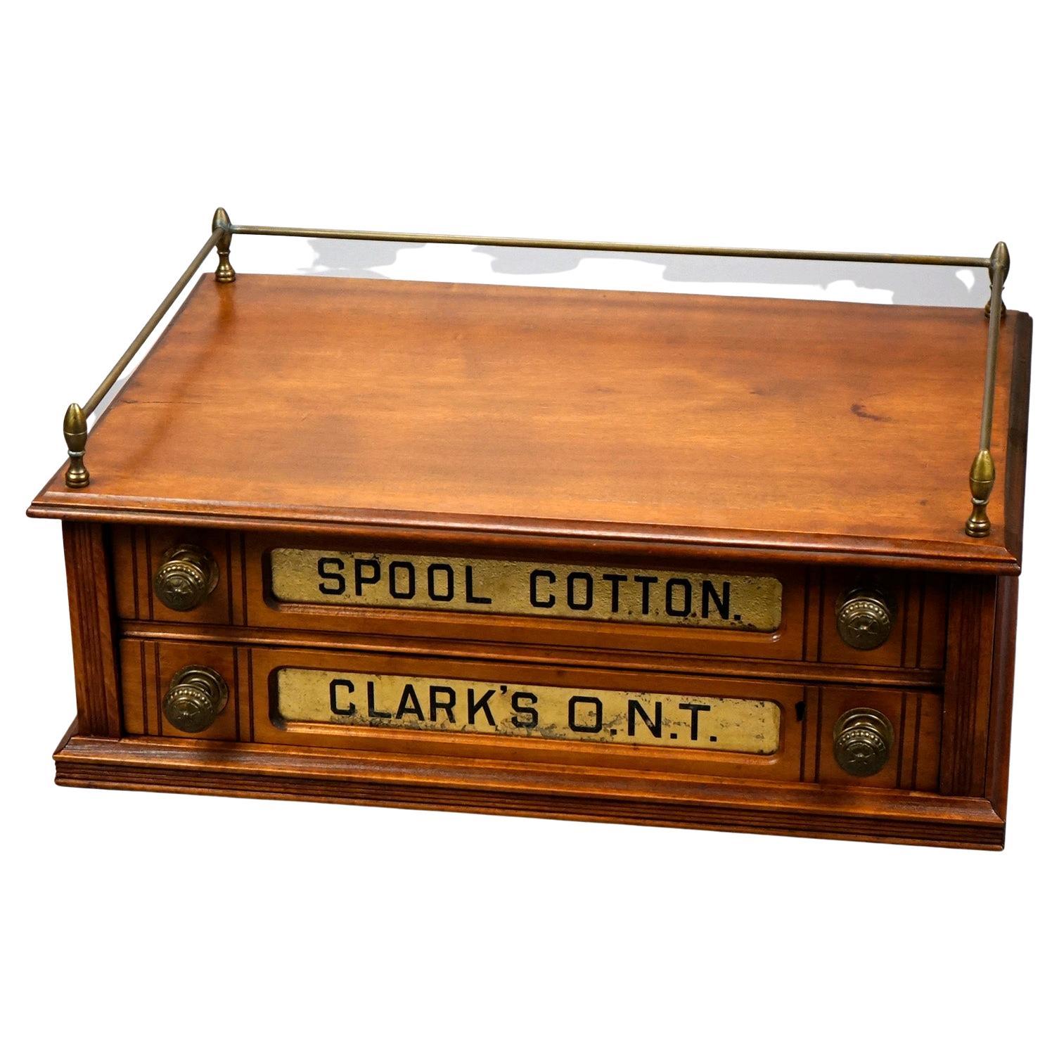 An antique Clark's country store mercantile advertising thread spool cabinet offers mahogany construction with upper gallery having brass rail over double drawer paneled case with advertising display, c1890

Measures- 9.5''H x 22.25''W x 15.5''D.