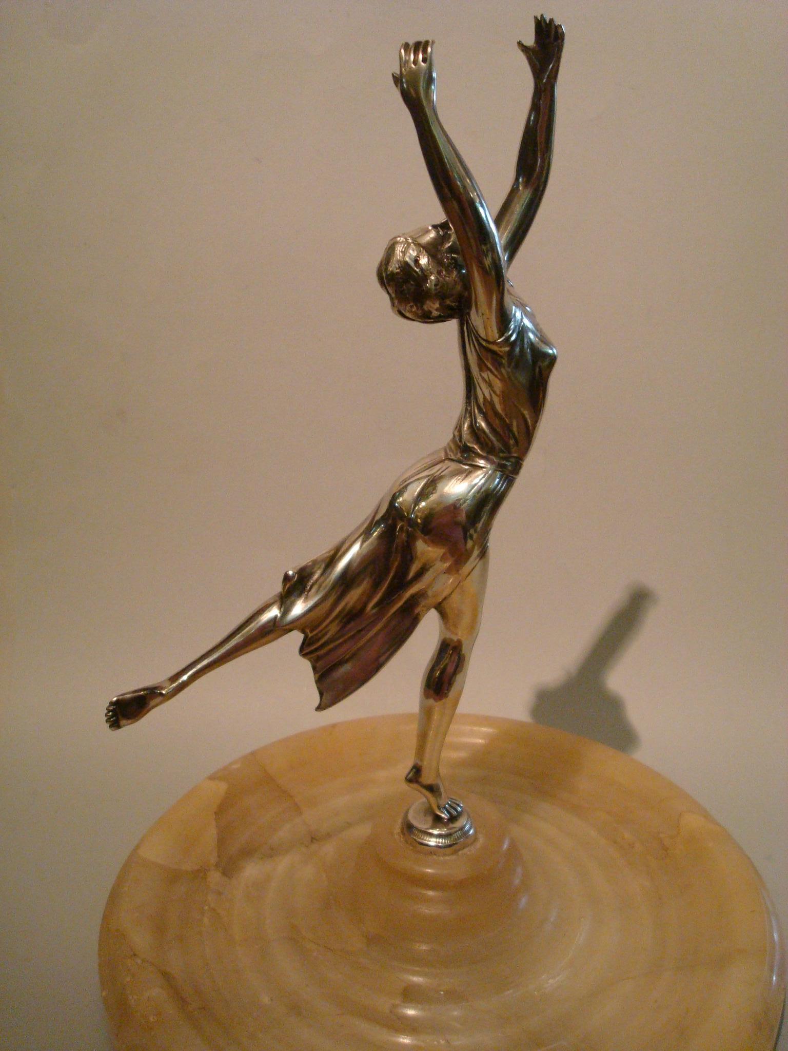 Silvered bronze sculpture of a women dancing. Lovely lady. It has a alabaster tray or plate that can be use for jewelry, personal cards or keys. Made in France, 1930s.