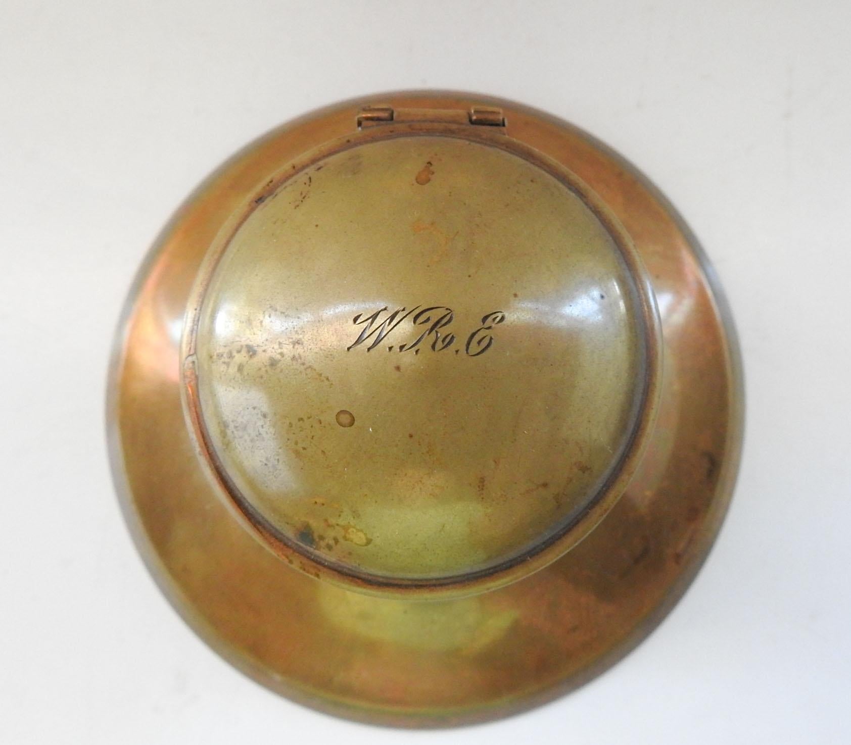 Circa 1890's brass inkwell with glass insert. Monogramed WRE on top, likely gilt finish at one time which has now worn off. Felt bottom, overall patina.