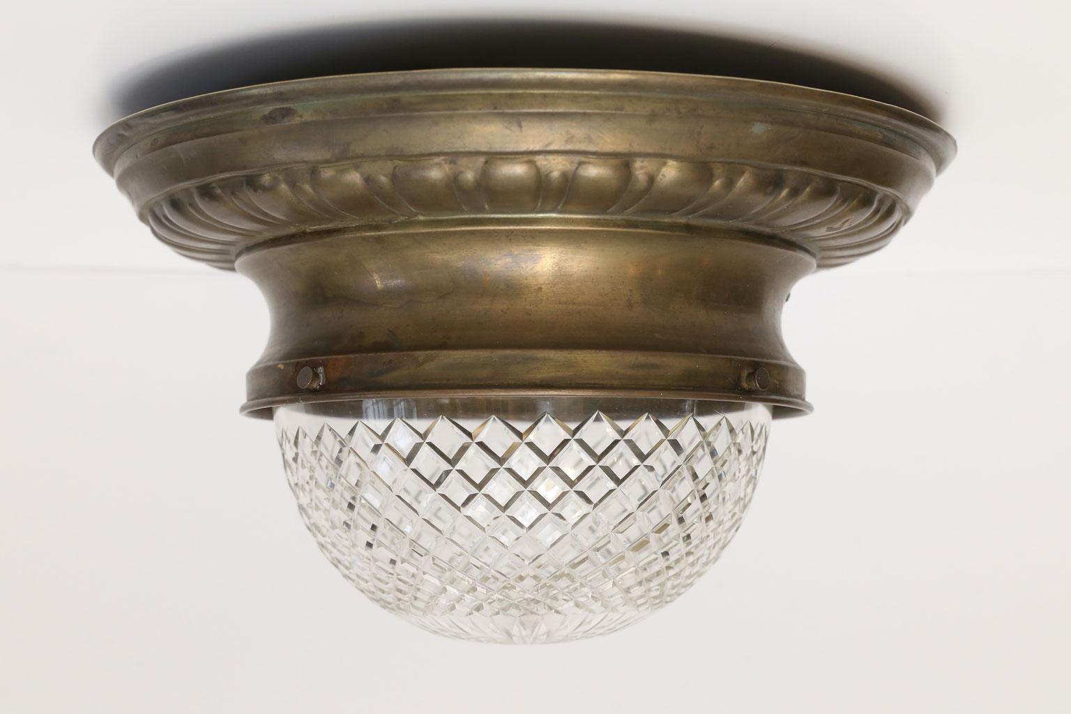 Repoussé flush mount light: brass fixture circled by repoussé decoration and finished with unusually deep cut-glass dome. This charming circa 1890 French light’s quirky proportions and elegant details will set the tone of a room. Perfect for small