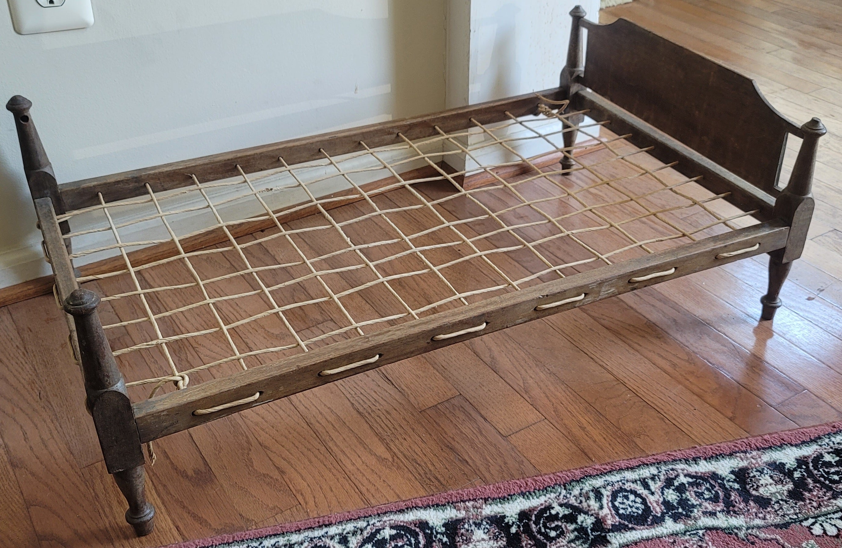 A rare antique baby doll rope bedframe in Classical American style.
Circa 1890s. Measures 20